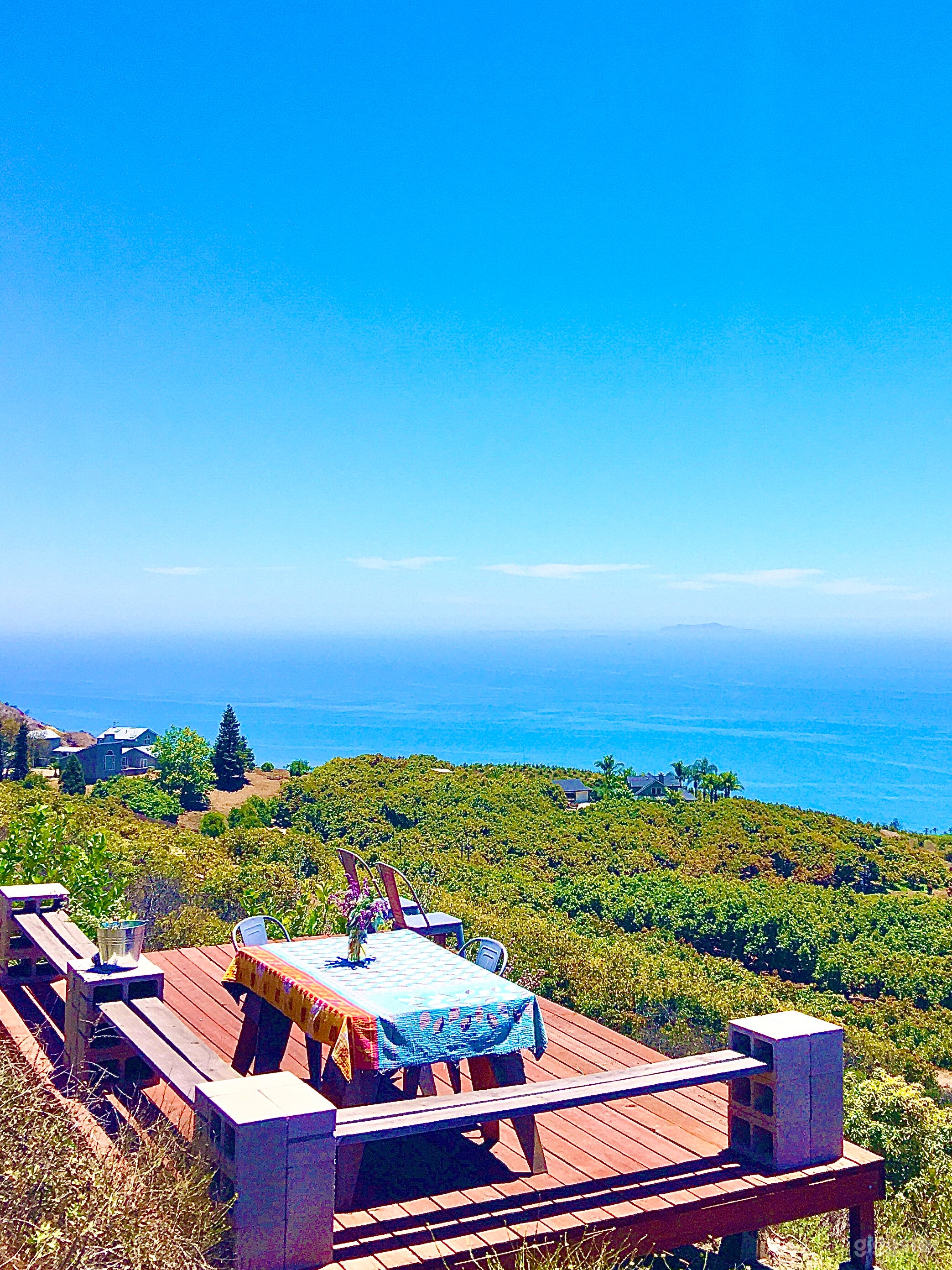 Panoramic view of Pacific Ocean from upper wood deck