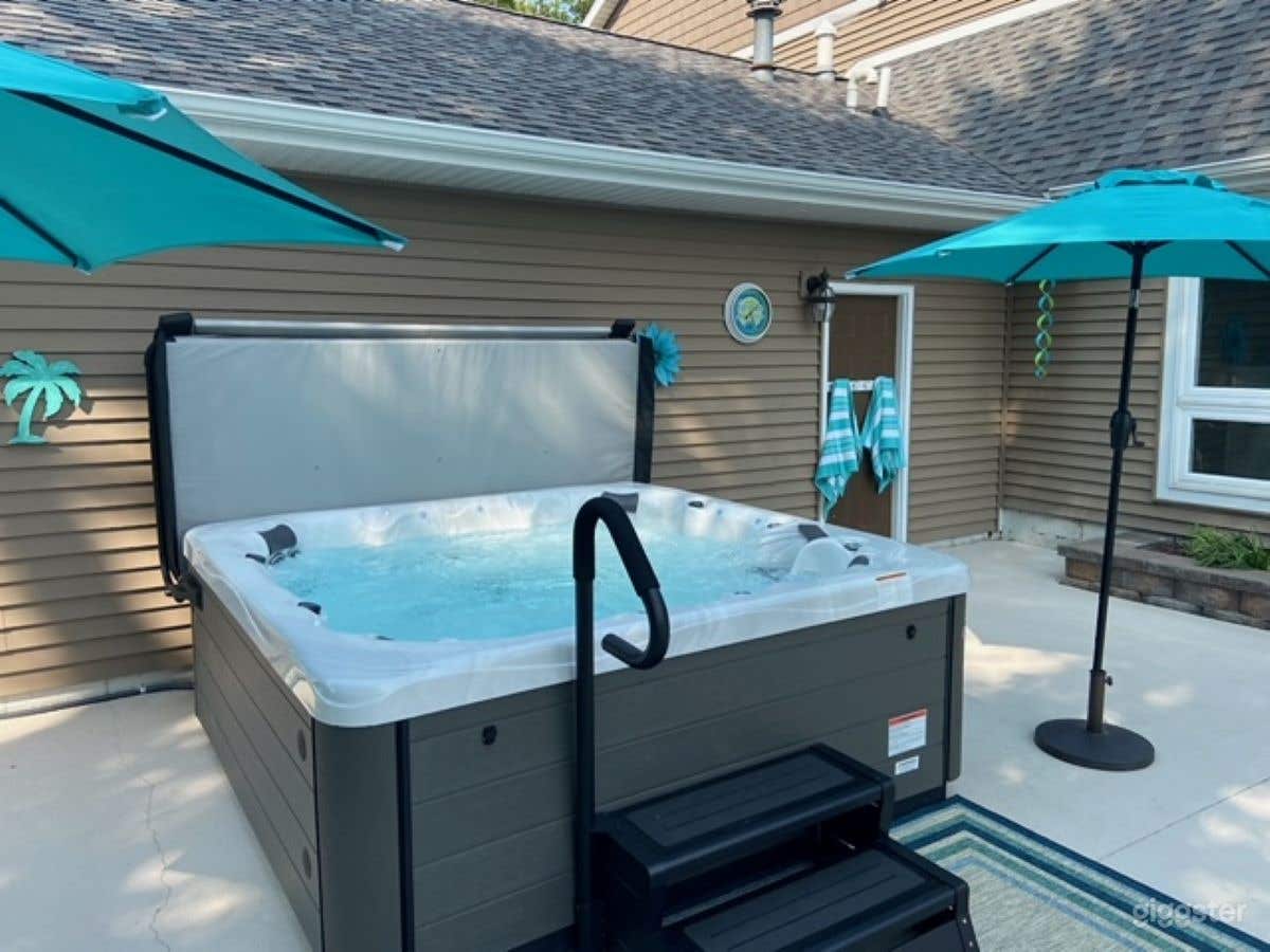 Outdoor Hot Tub Facing Fountain and Tennis Court