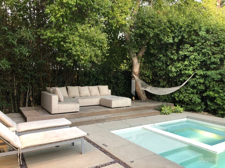  Modern house, pool, trees and green landscaping.  