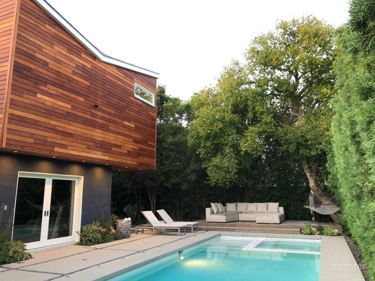  Modern house, pool, trees and green landscaping.  