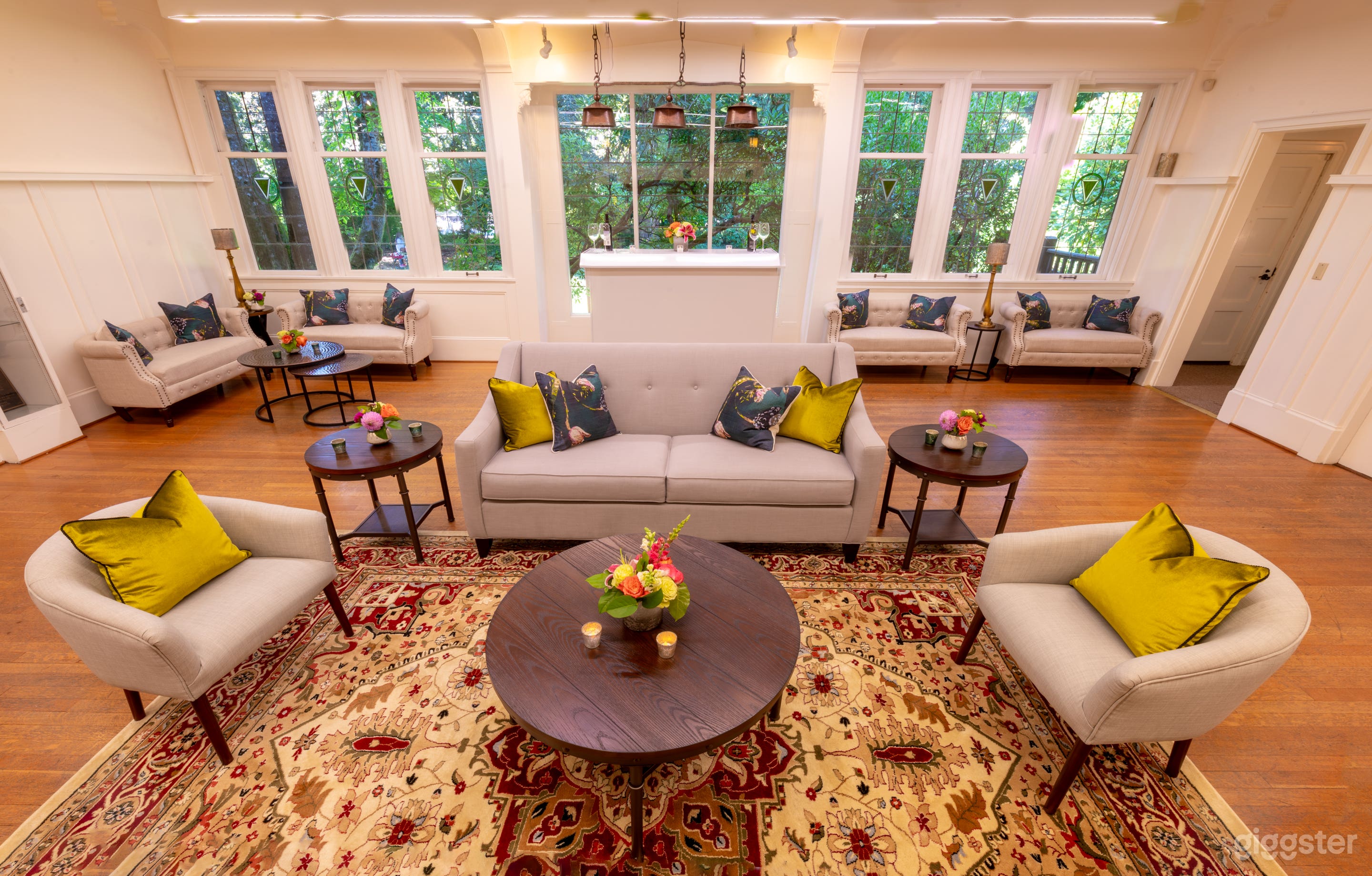 Billiard room with a fireplace and original stained glass windows.