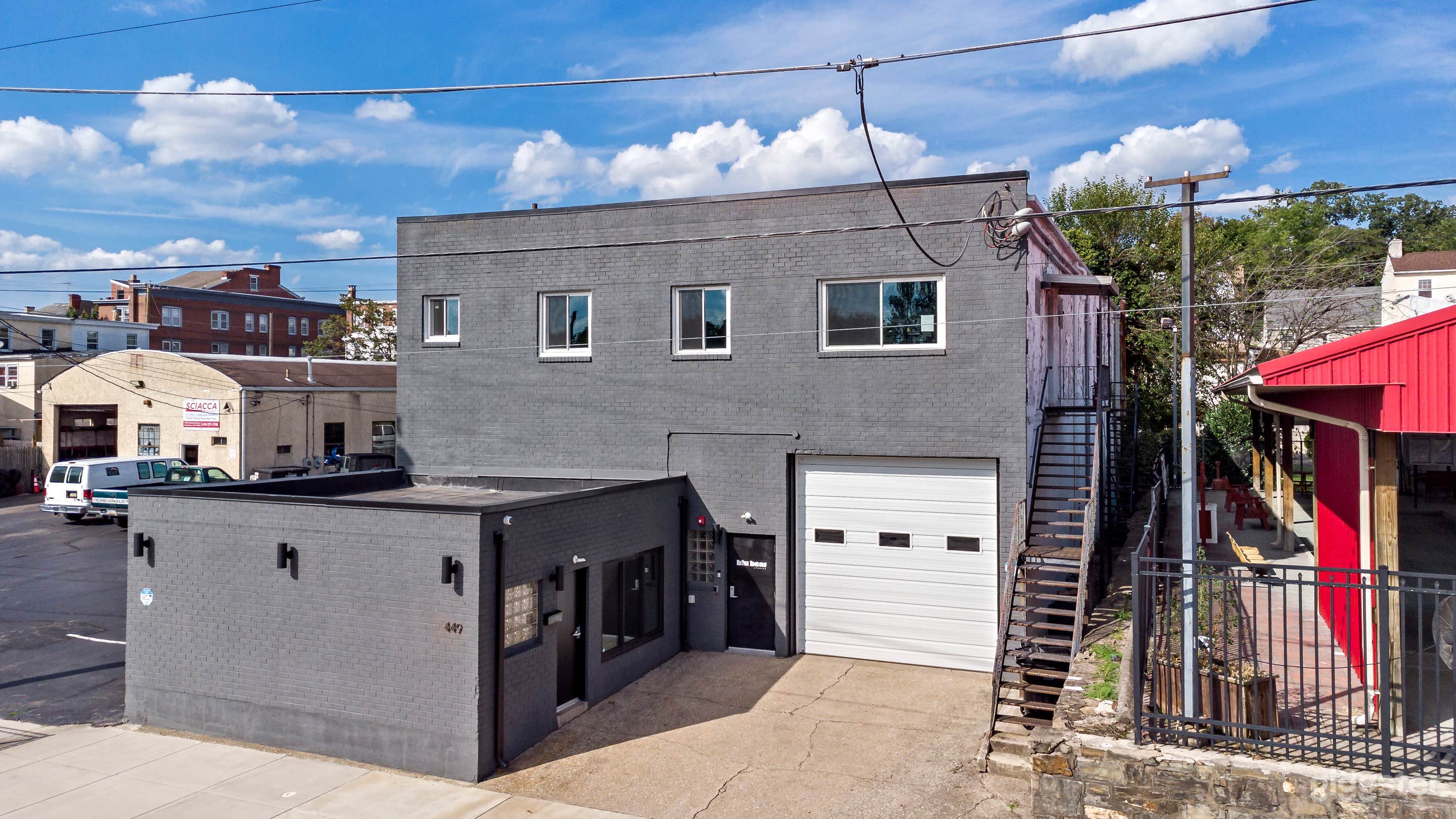Exterior w/ large street level garage door access