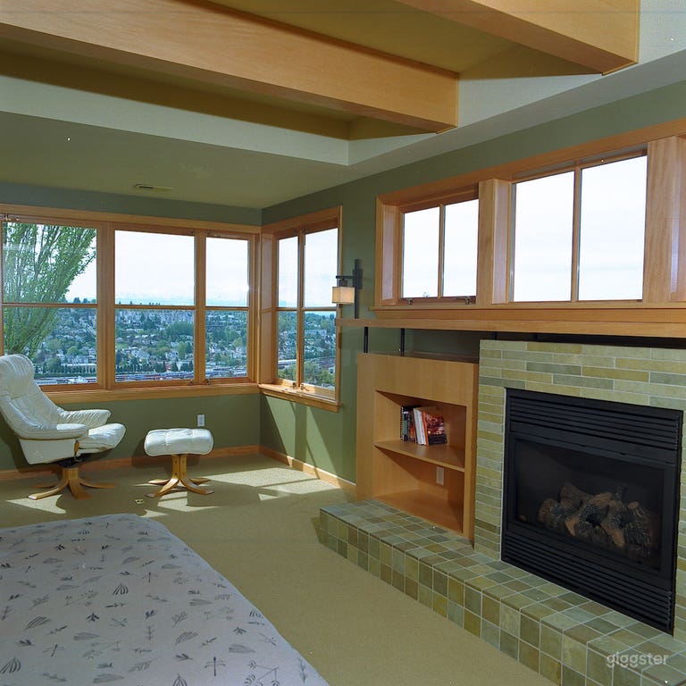  Master bedroom with fireplace and western view of Puget Sound and Olympic Mountains 