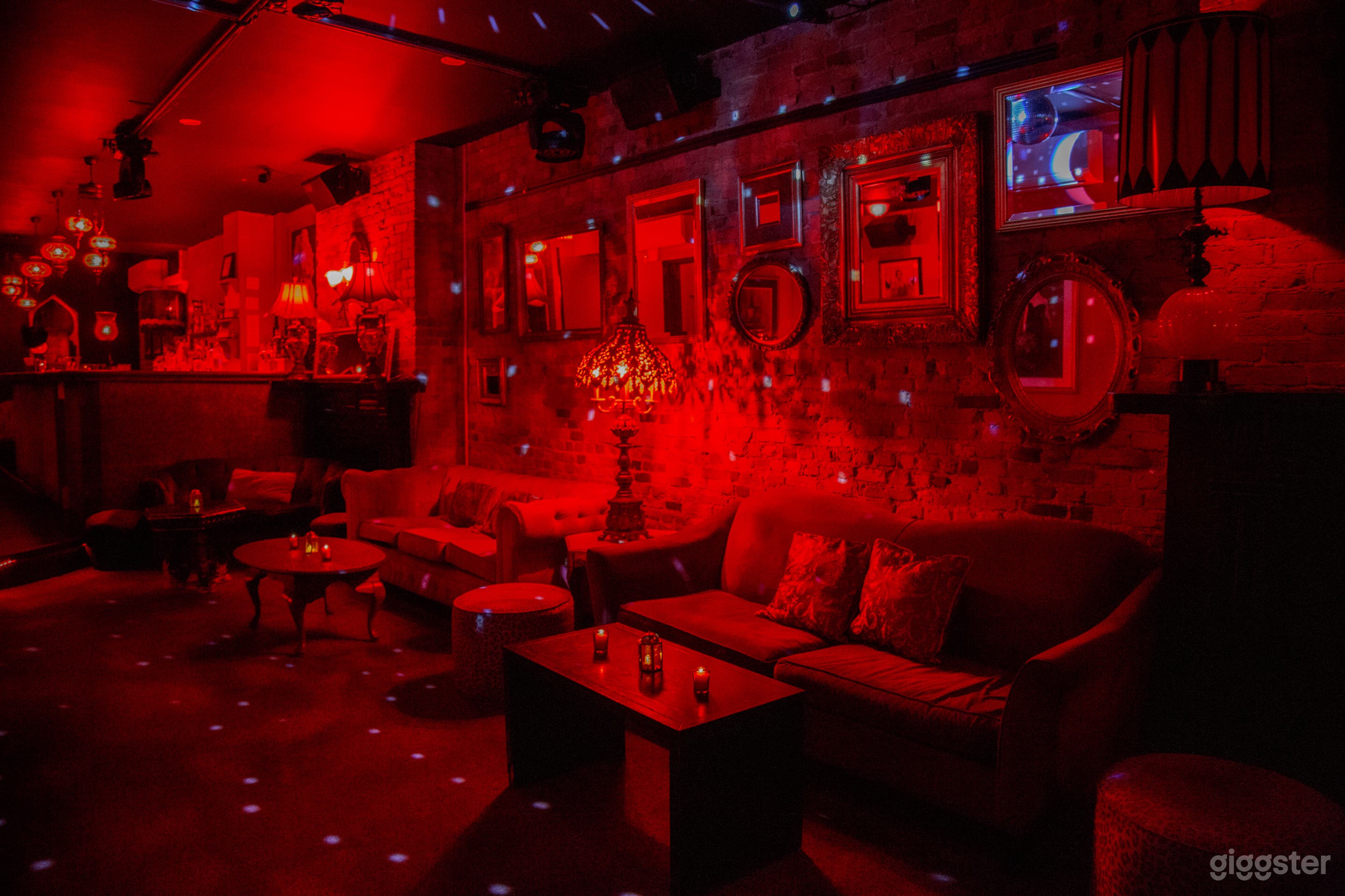 Mirrors, brick, and sexy red velvet line the walls. 