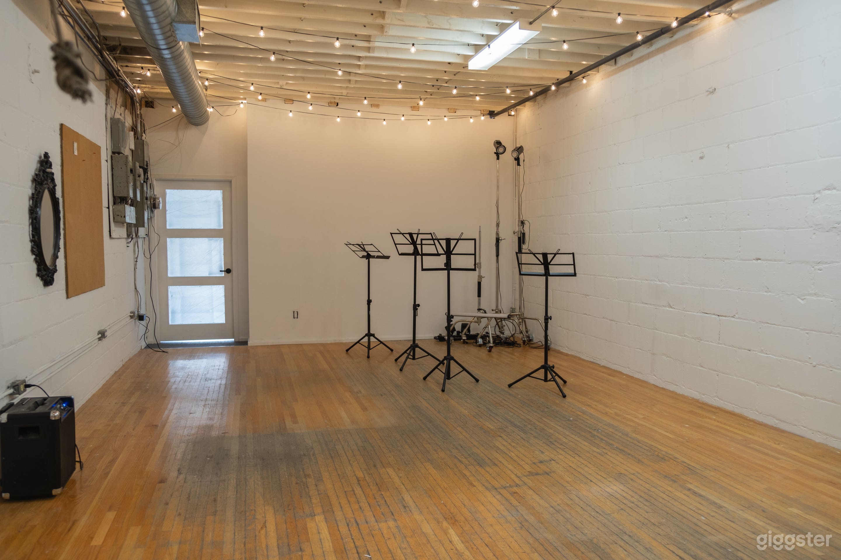 Industrial studio space - 15 x 30 Foot studio with flat white walls, dimmable string lights and equipment for rent