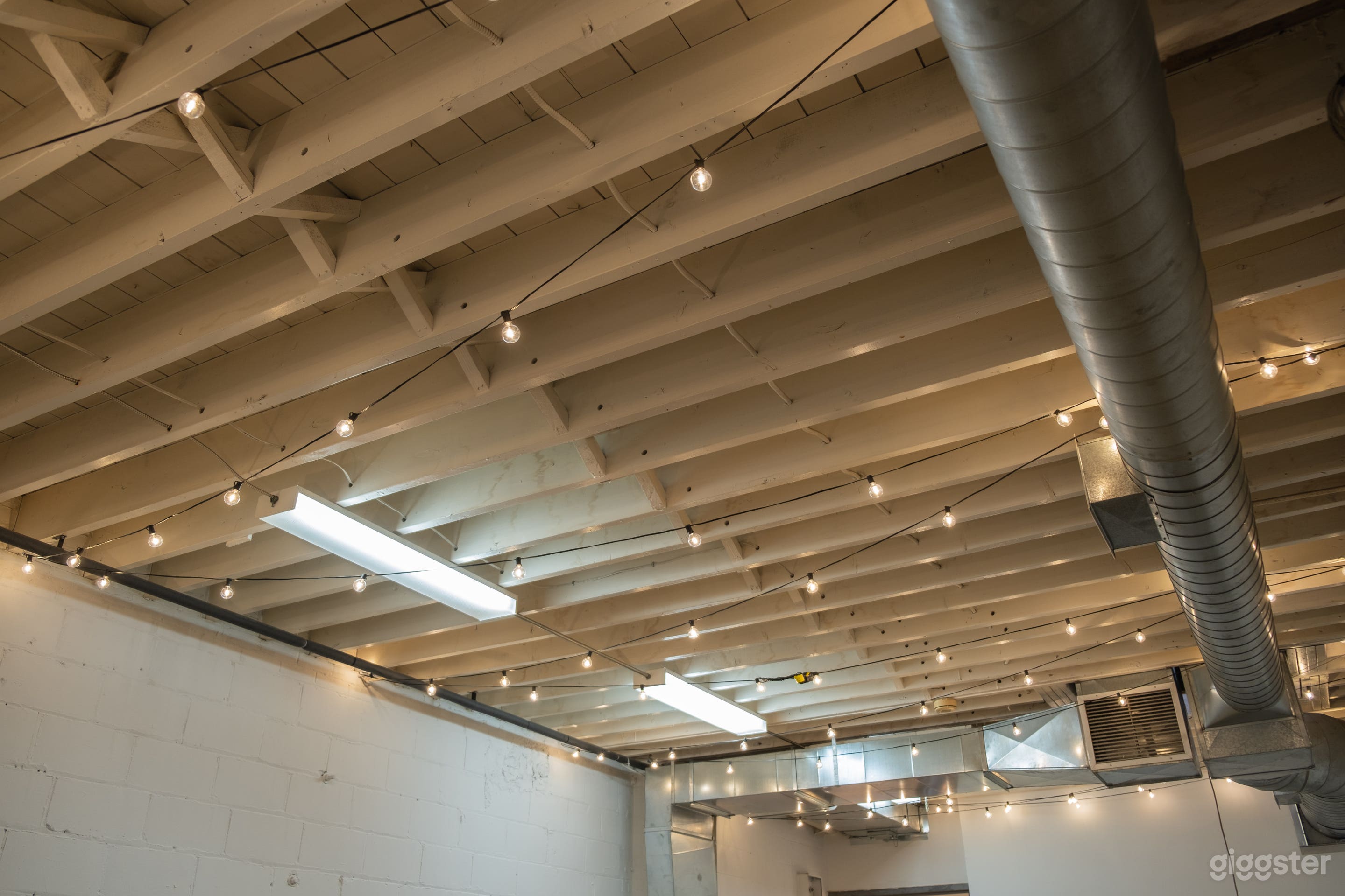 Industrial studio space - 15 x 30 Foot studio with flat white walls, dimmable string lights and equipment for rent