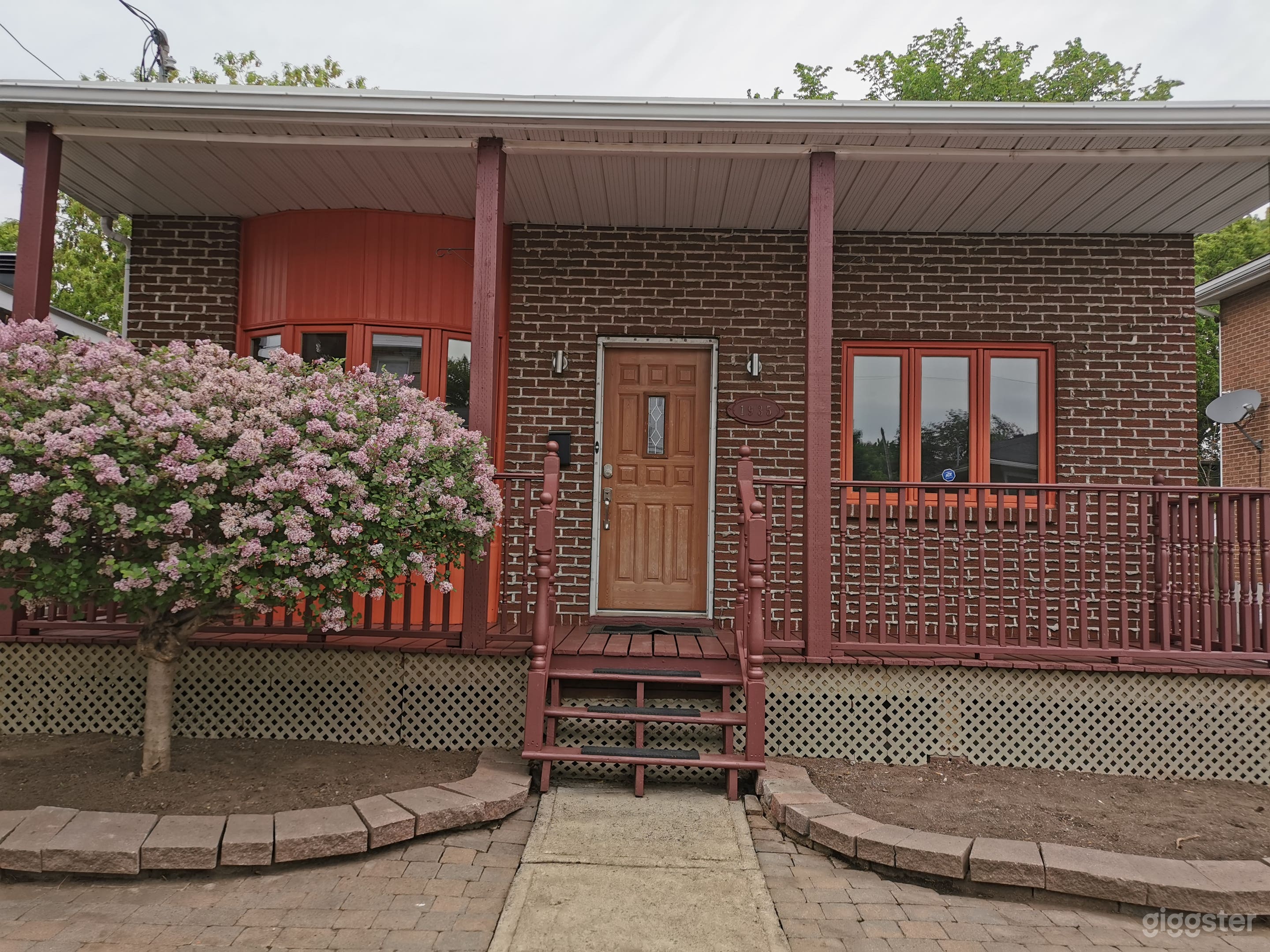 Main entrance with large wood patio and bay window