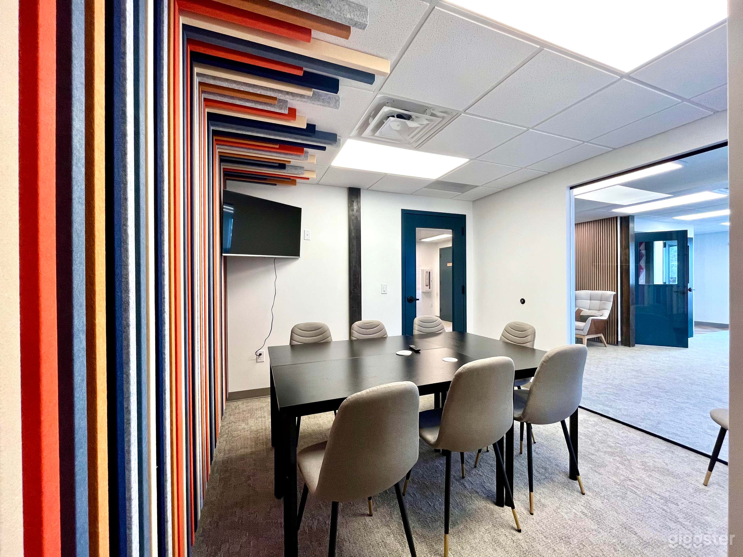 Modular conference and podcast room with colorful backdrop.