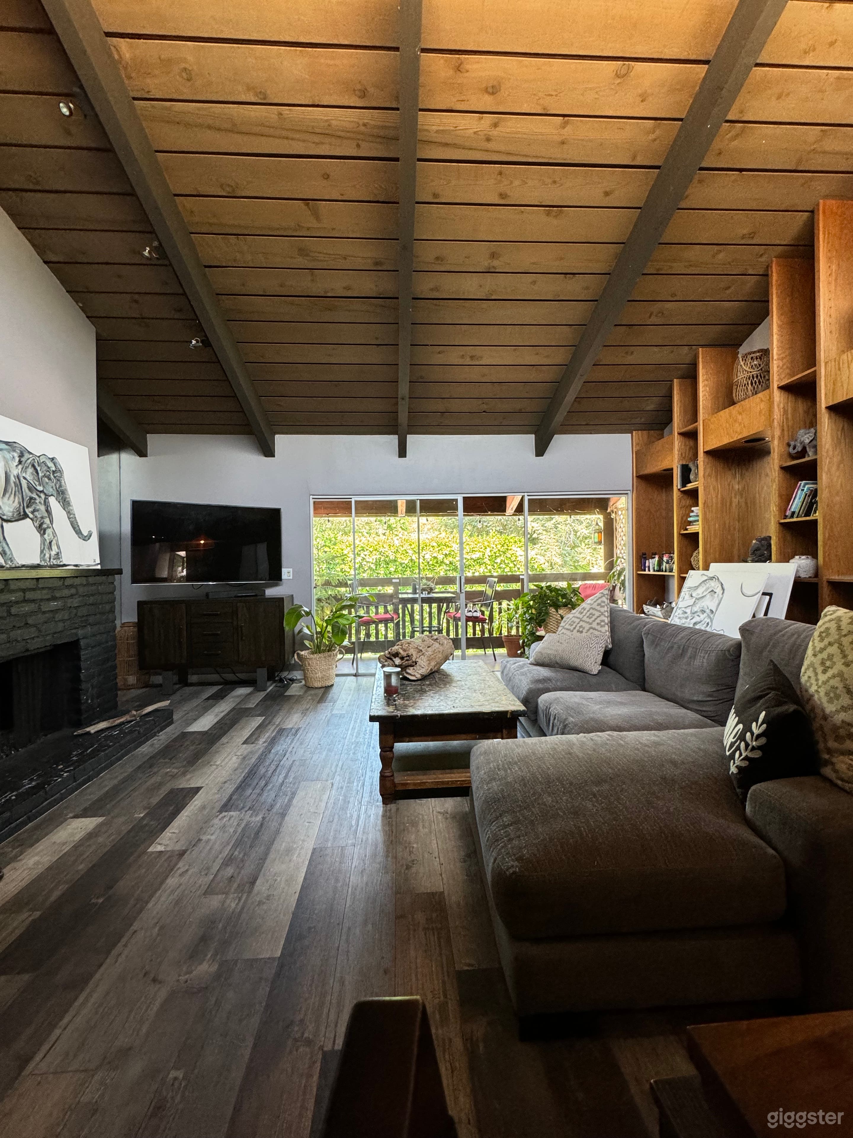 Living room with fireplace and balcony view.