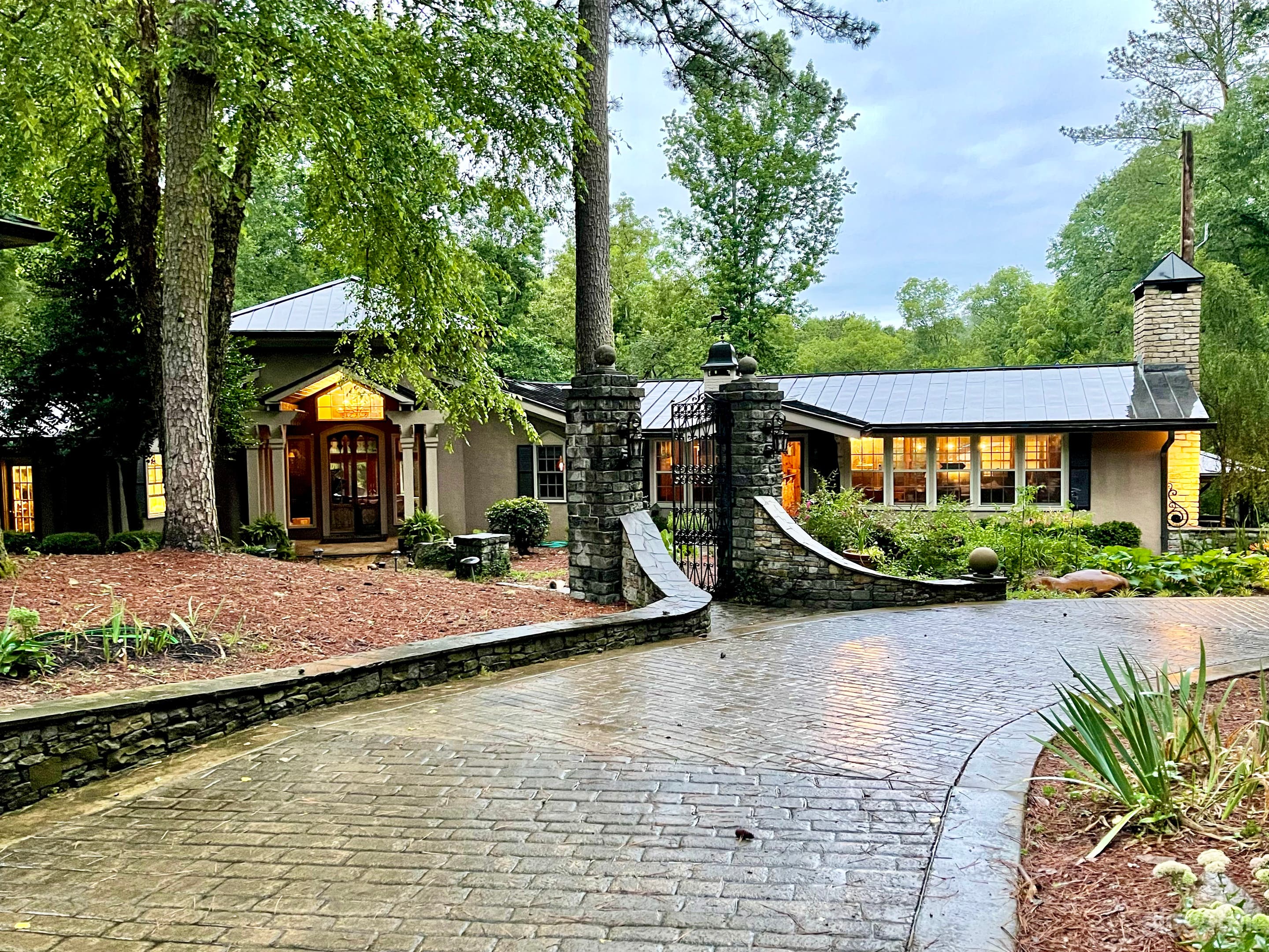 One of a kind English Country Style Manor House with an unexpected 1950's hunting lodge wing and Tuscany inspired owner's suite. Stone and Iron Gates welcome guests to stone pathway leading to main entrance through antique french wooden doors.