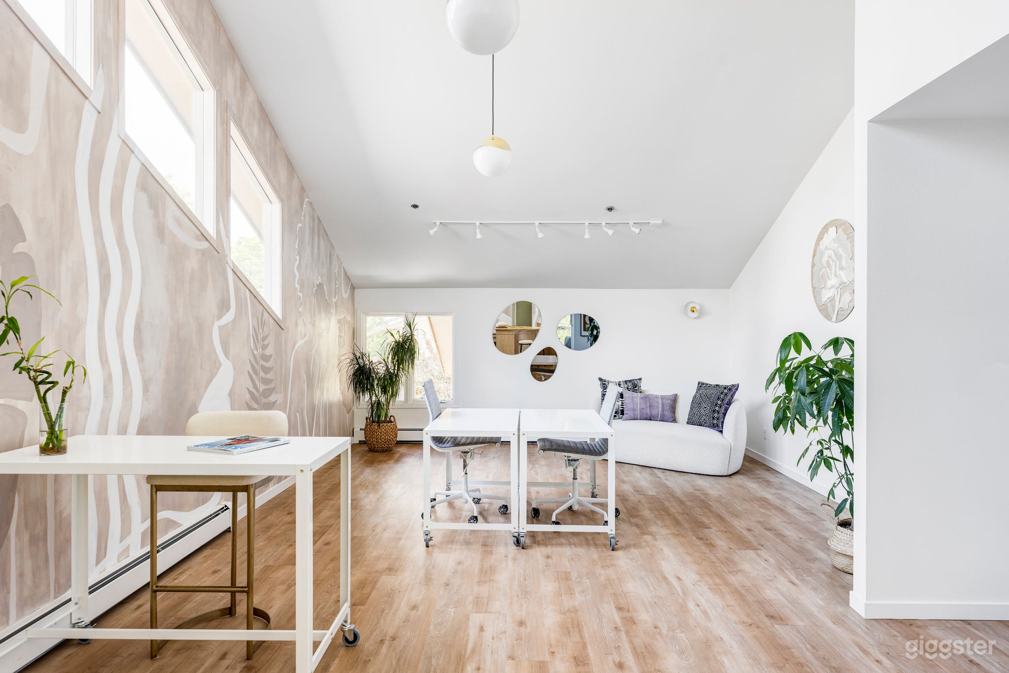 Side gallery with sloped ceiling and transitional furniture. Can be cleared for meetings or photoshoots.