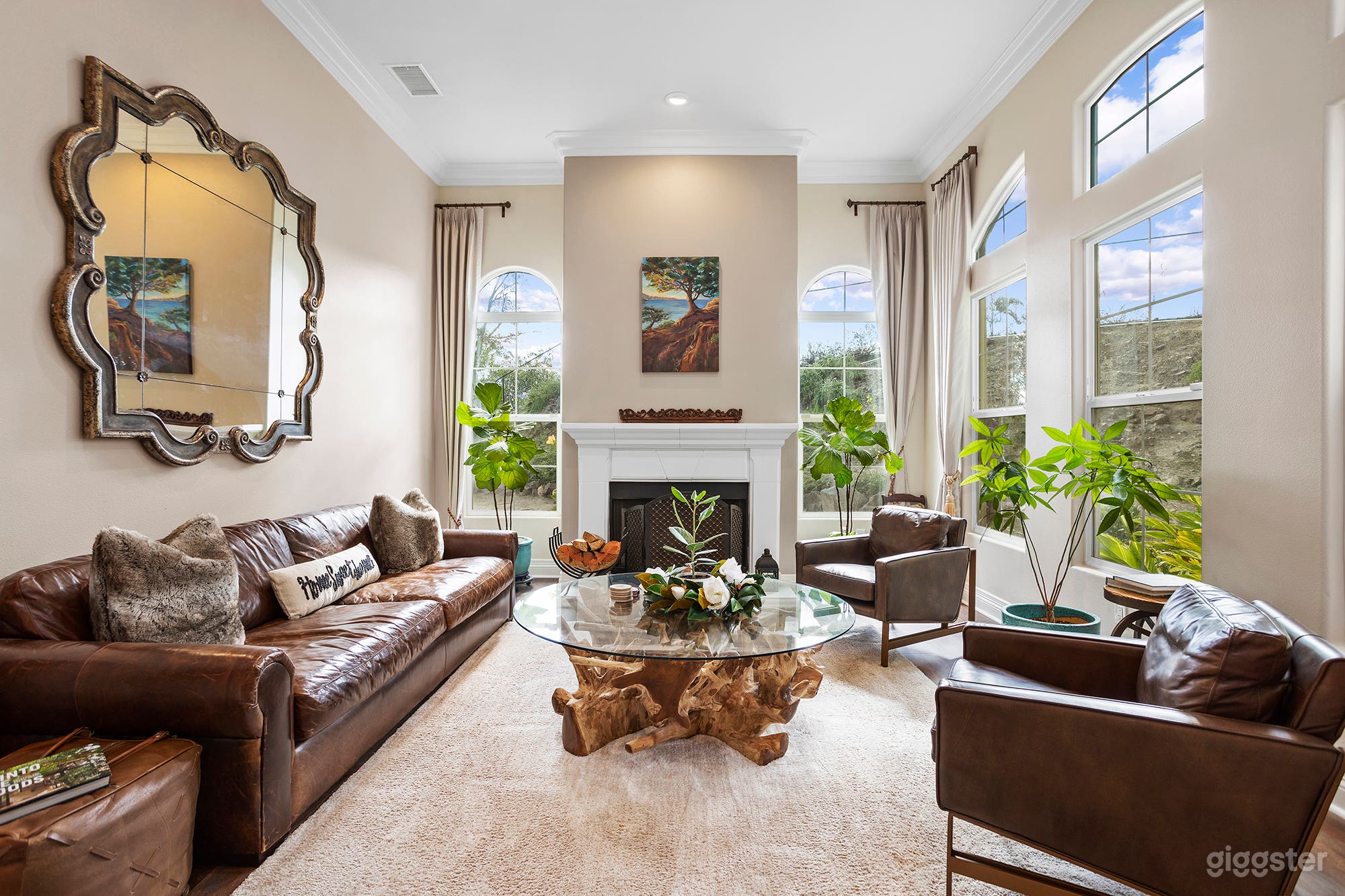 Living Room with Large windows looking out to outdoor landscape and fireplace