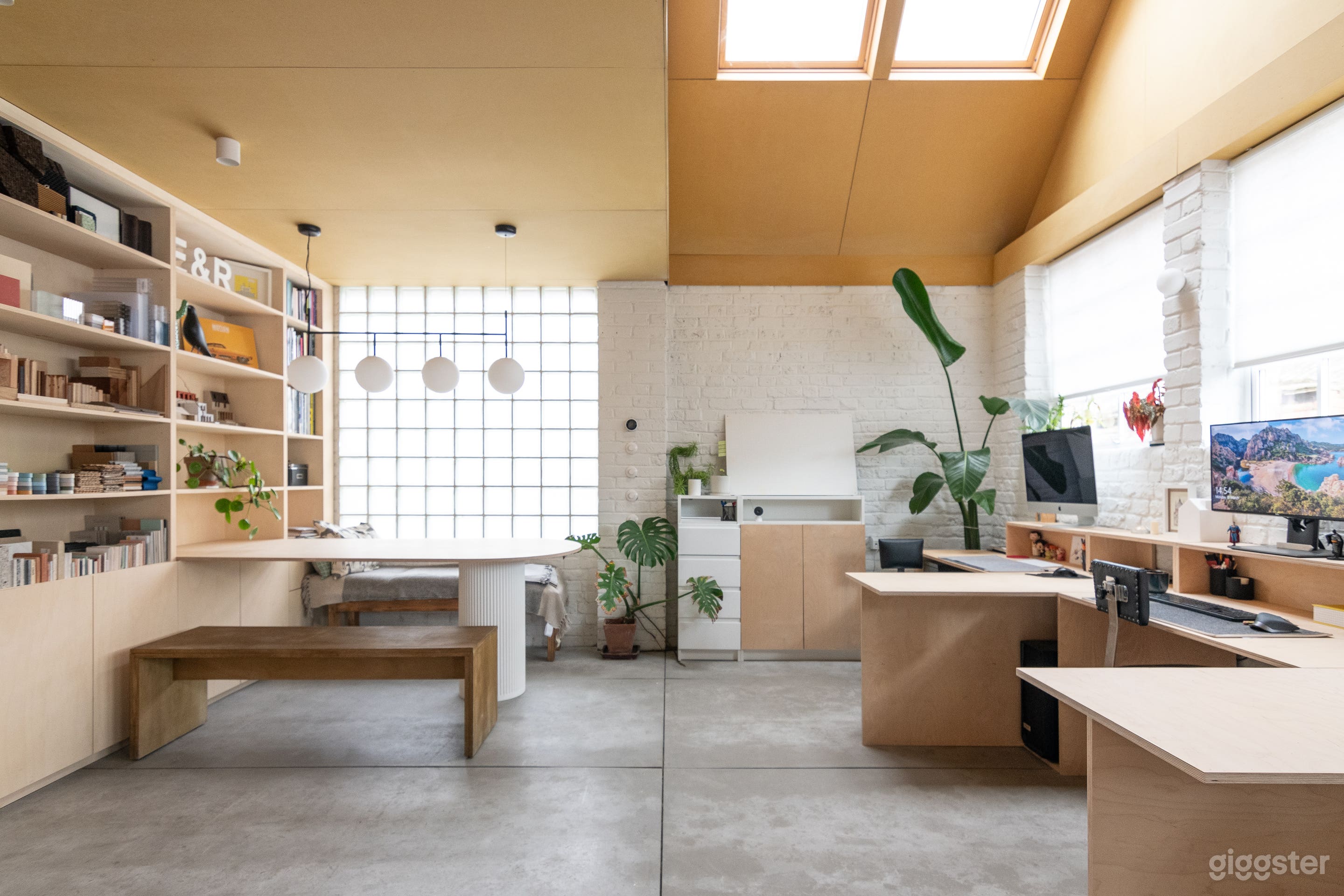 Main space with double height and yellow wood-clad ceiling