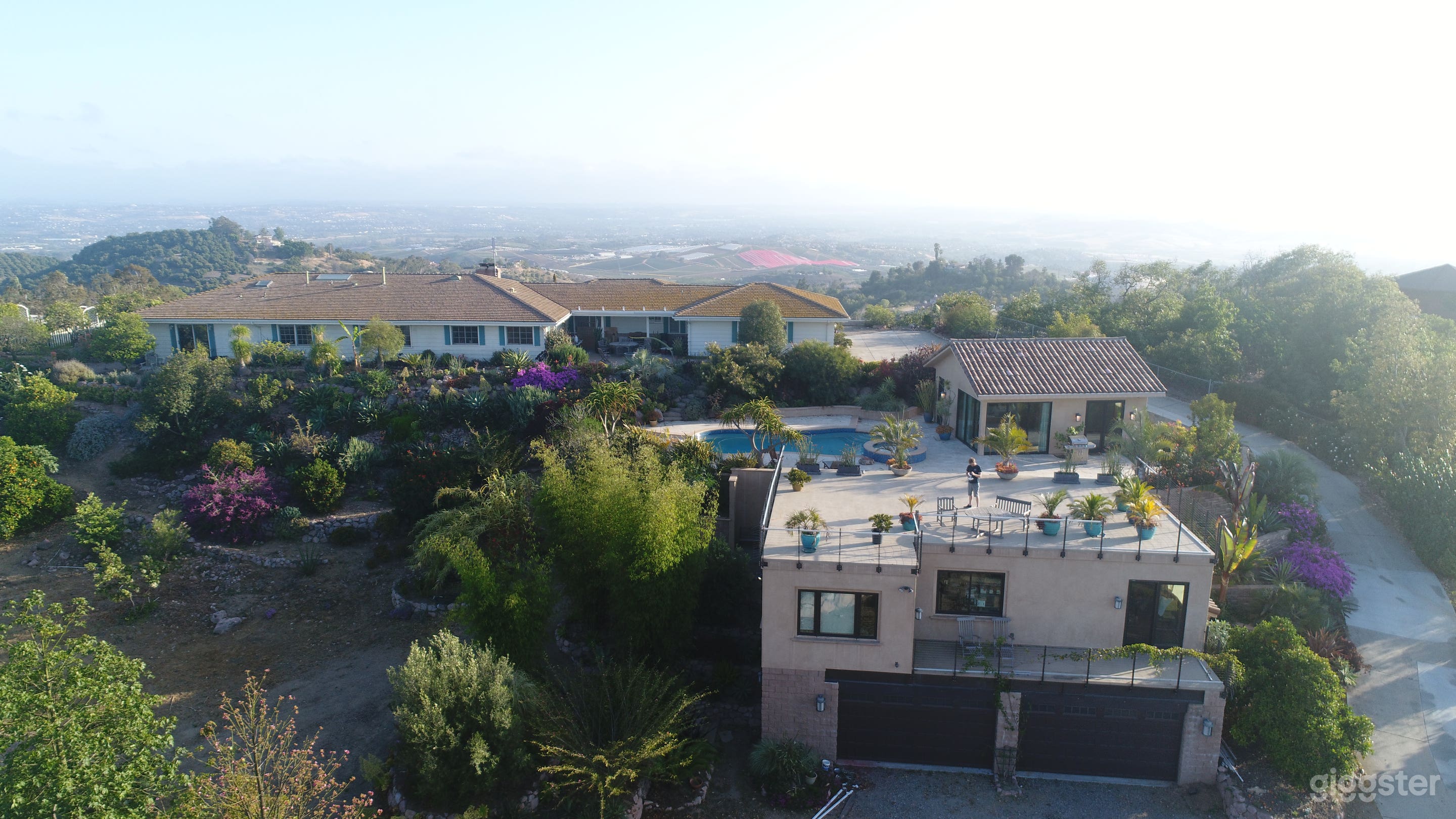 Deck over guest house project, pool, pool house, main house at top of hill 
