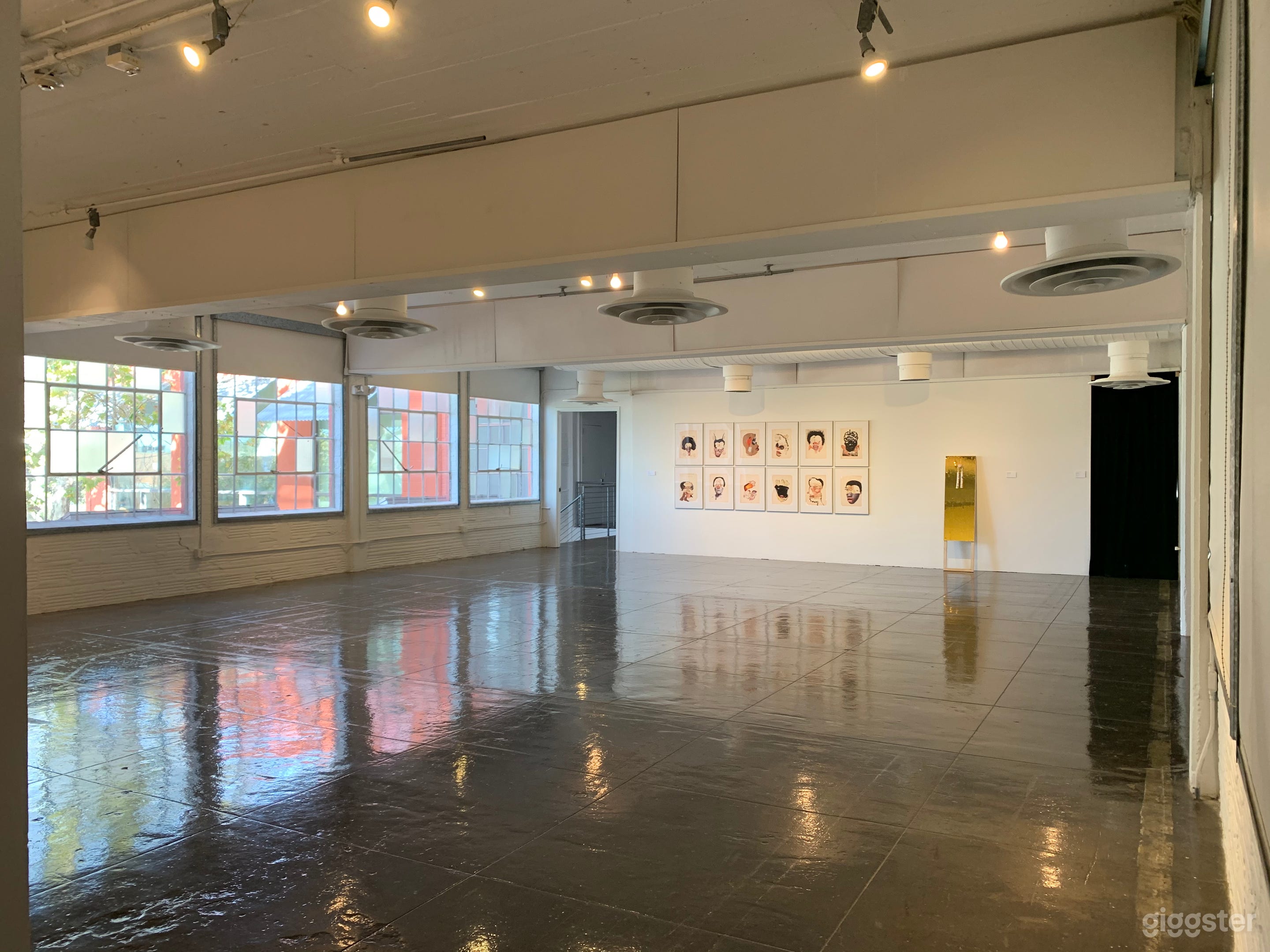 Hudson Showroom with windows showing the colorful building walls. 