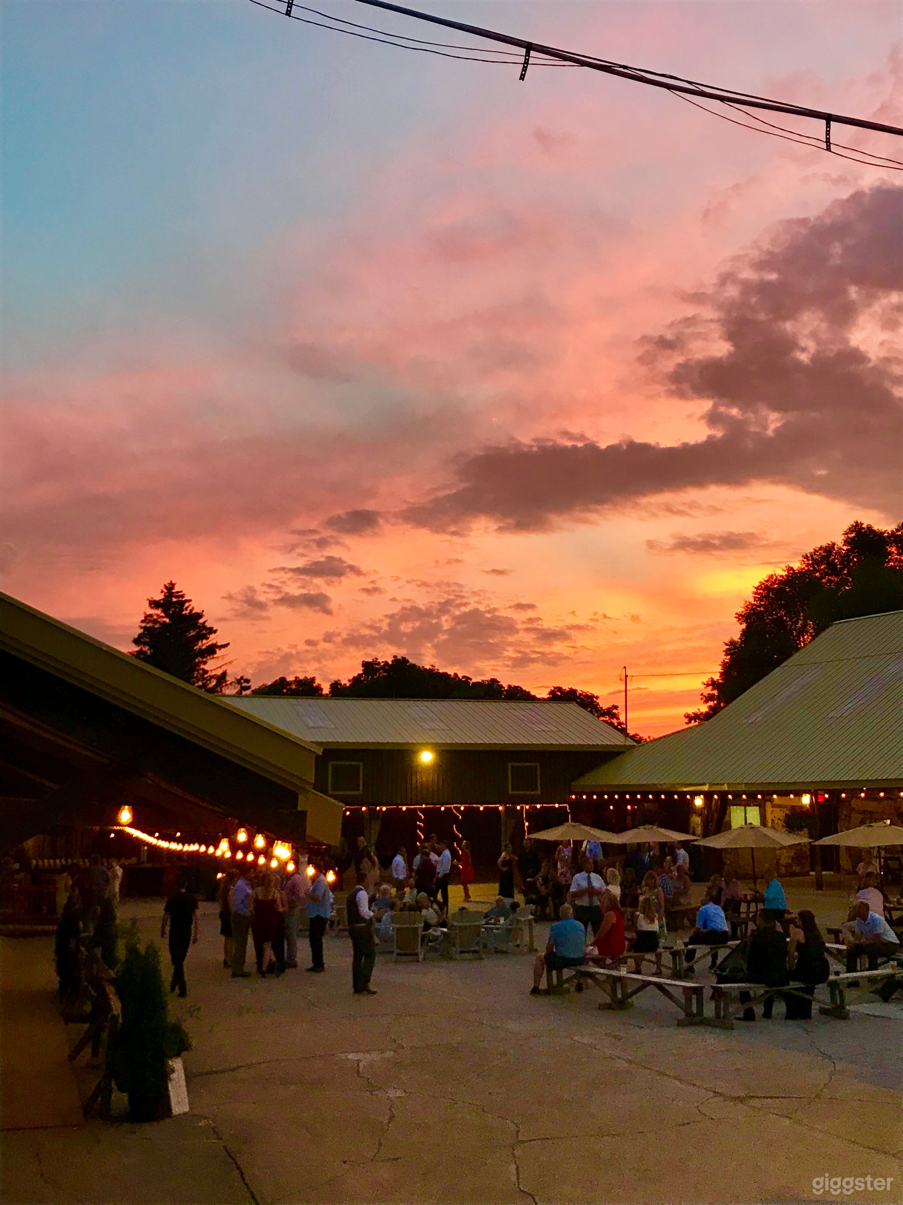 three gorgeous open air barns with edison lighting, wood beans and stone walls