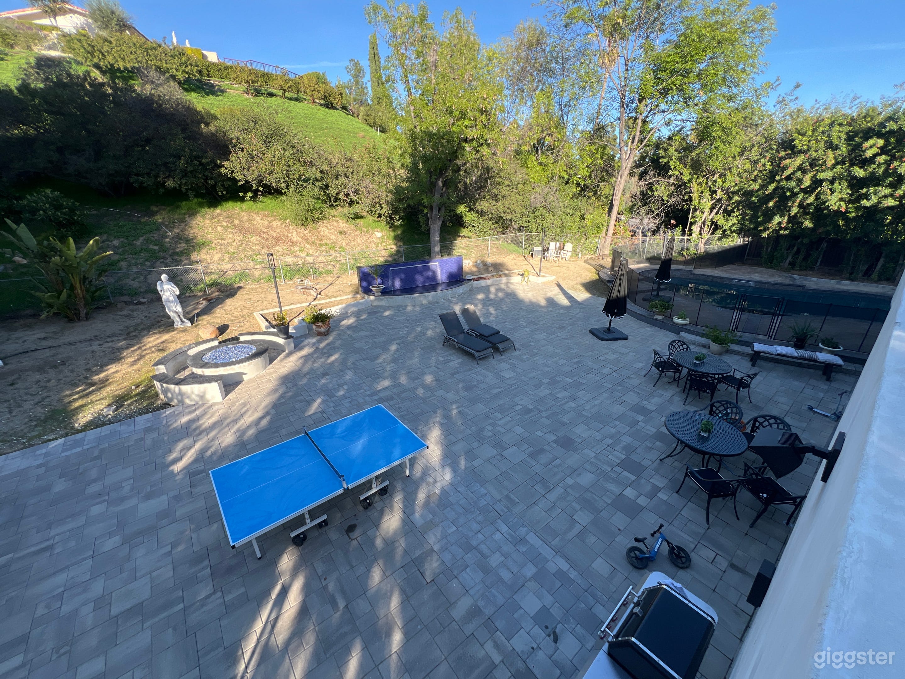 Giant backyard with pool, fire pit, ping pong table and lots of seating area