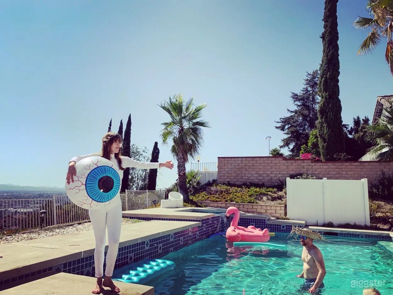 Scenic Hillside Pool with Attached Spa Photo 1