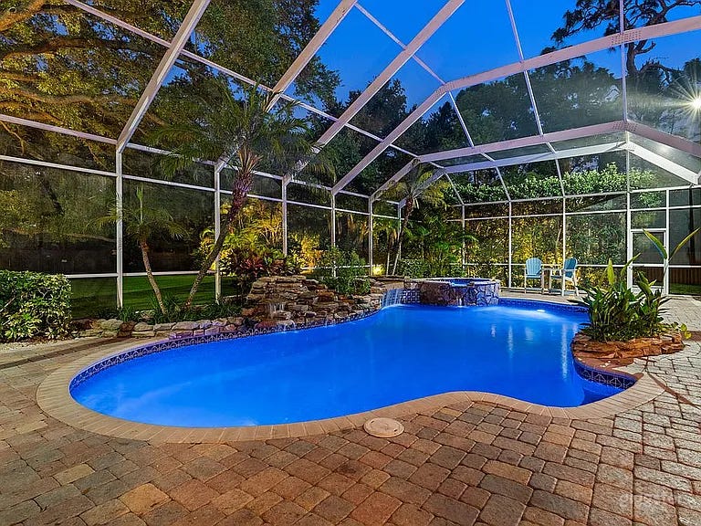 Tropical Screened Pool Estate w Waterfall Spa & Lush Grounds Photo 1