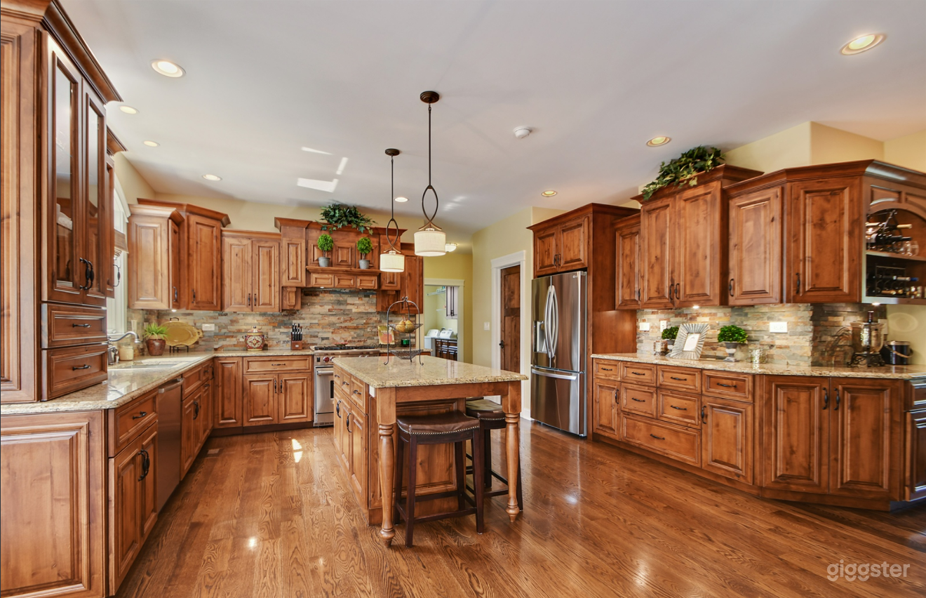 Custom kitchen with knotty alder cabients and stone backsplash.