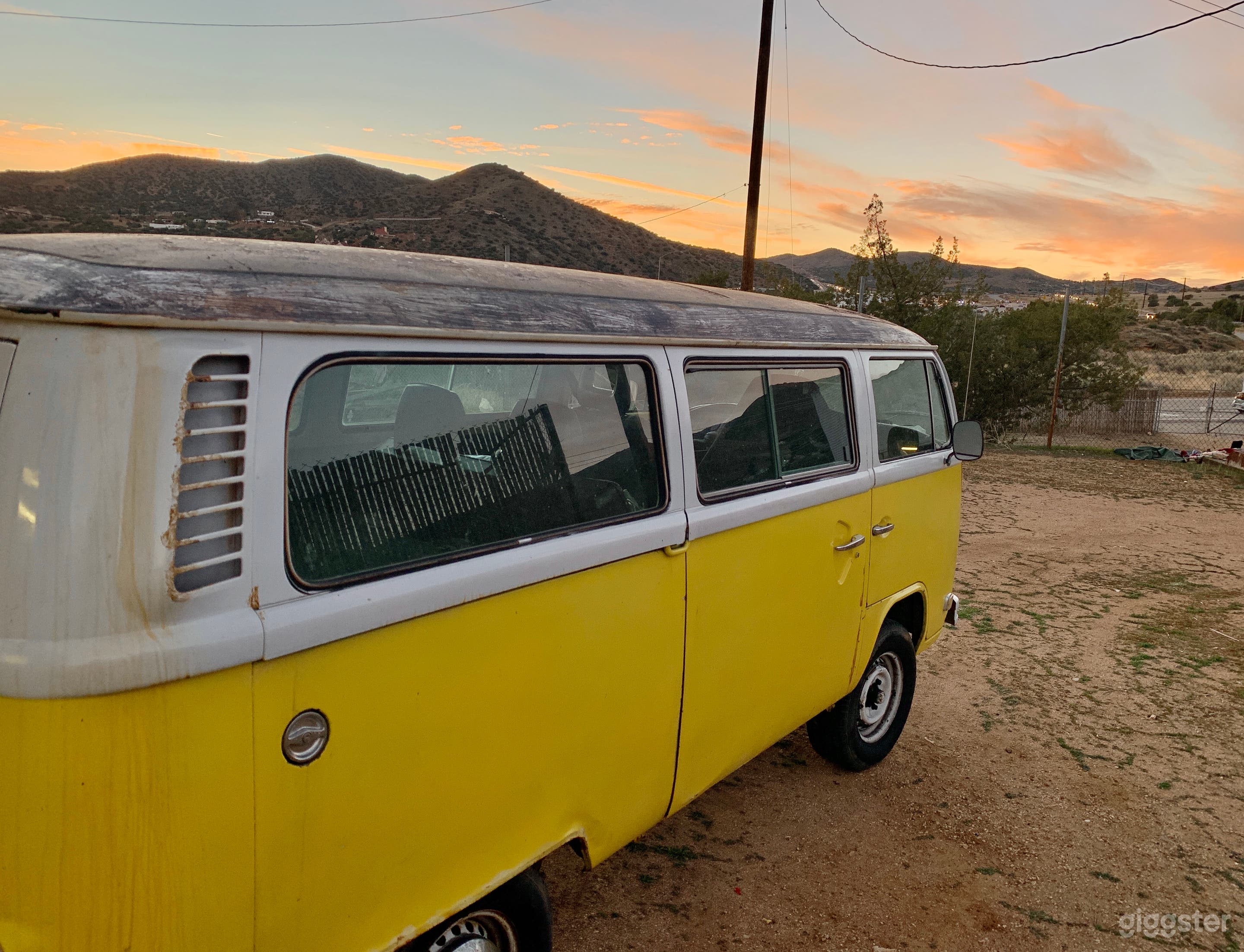 Our 1979 VW 7-seater hippie van on our property with the beautiful desert sunset toward LA.