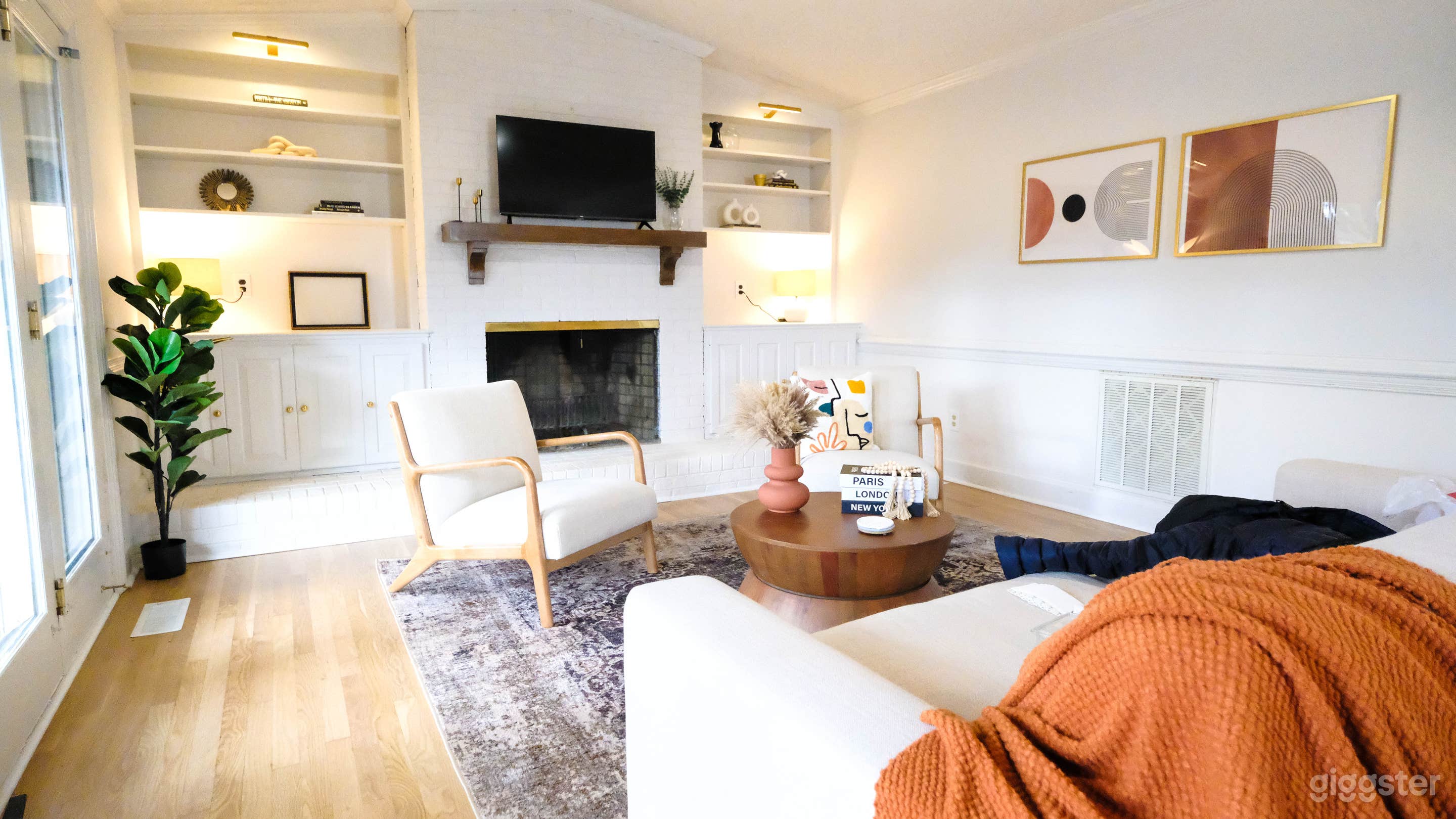 Spacious second family room, plenty of natural light, book shelves, fireplace, TV, home office space with desk