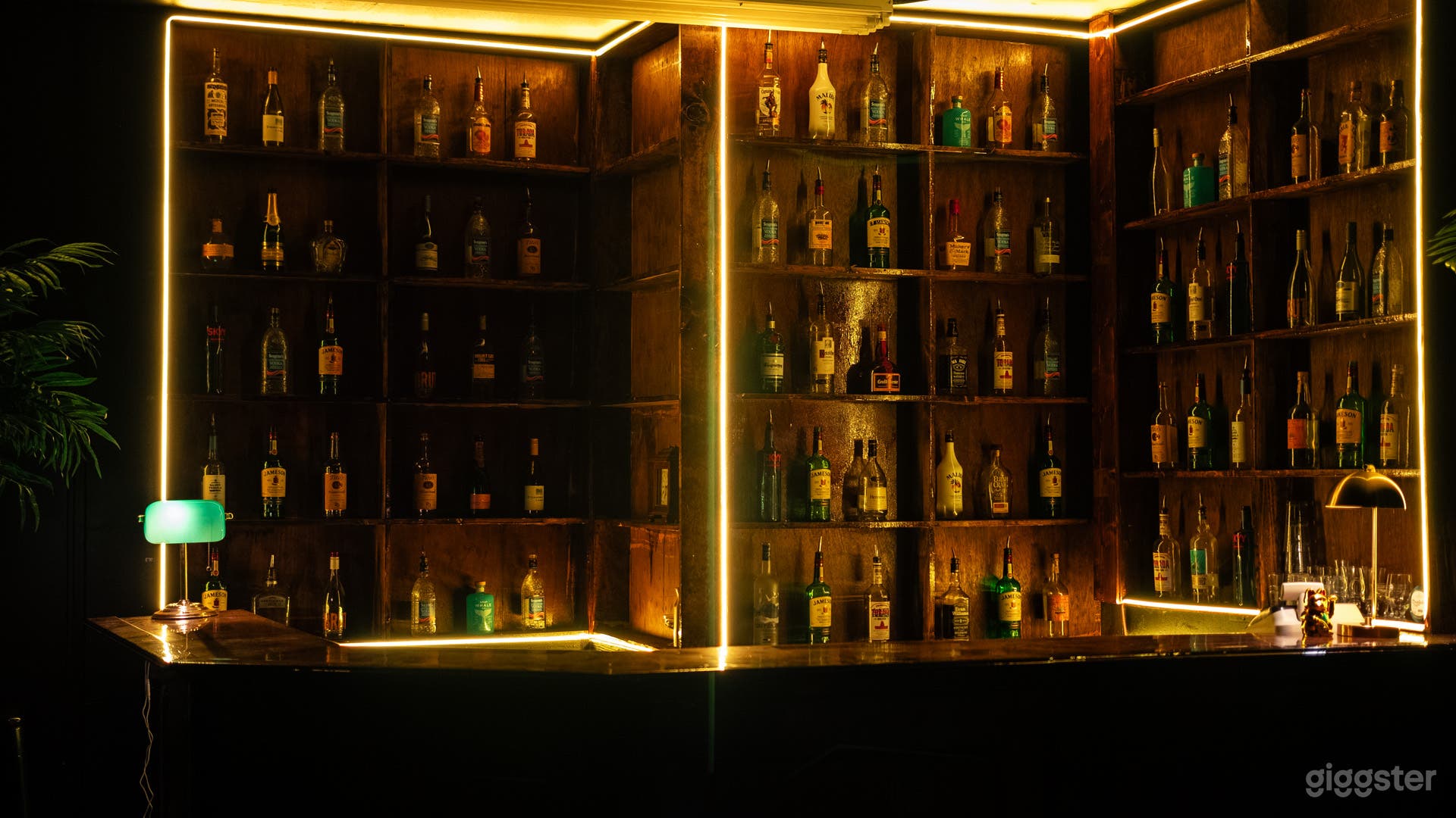 Bar set, LED lights, liquor bottles decor, red bar stools, stage, accent lounge chairs.