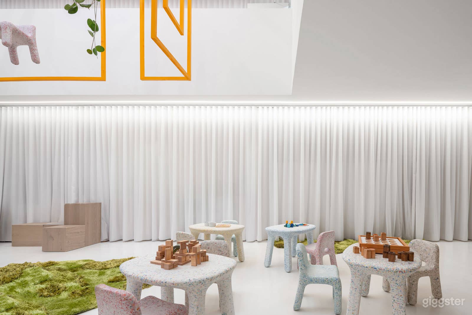 Breezy curtains throughout the space conceal storage and a coffee station 