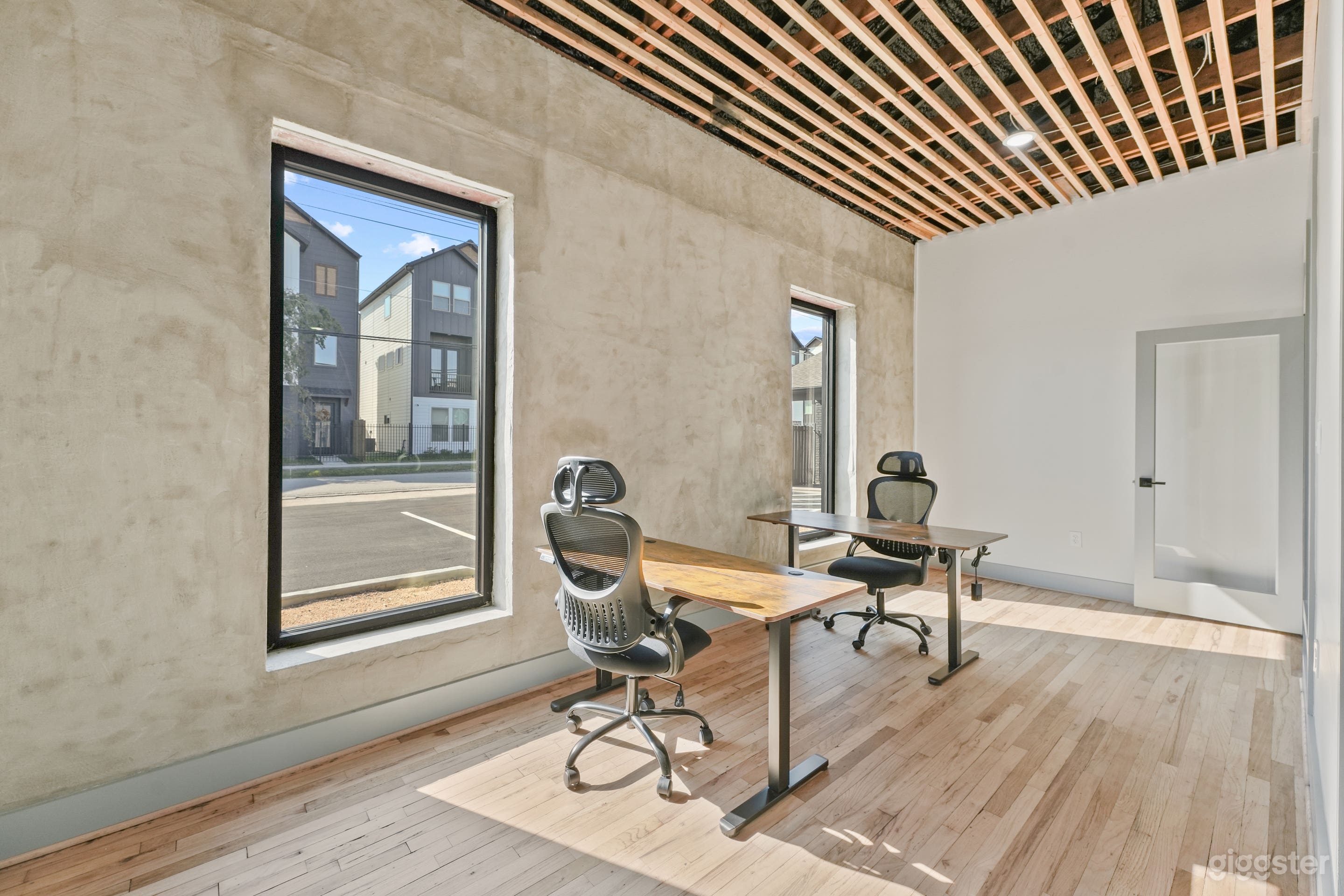 Private office space with standing desks and ergonomic chairs.