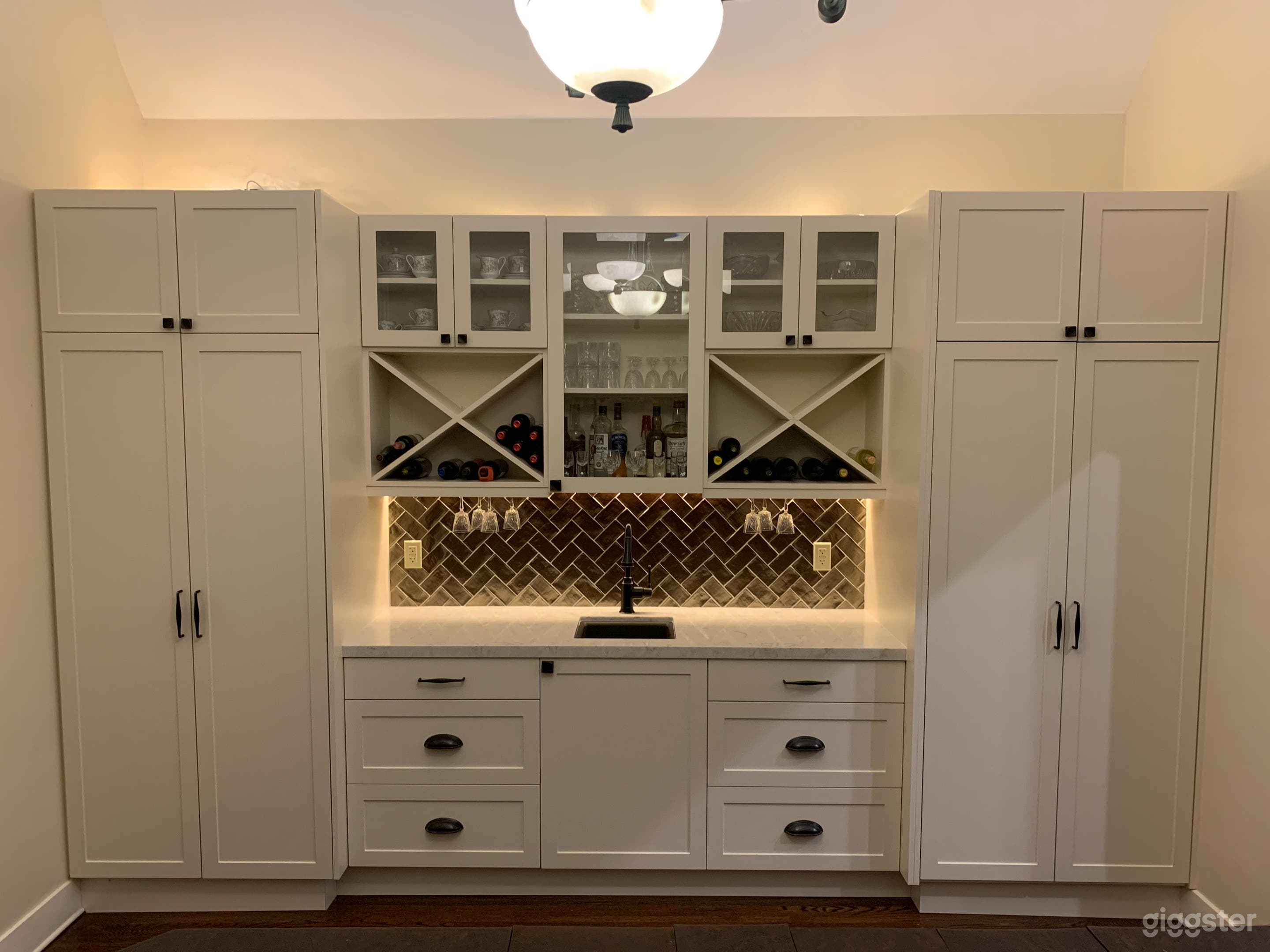 Dining room shares high ceiling of living room, with dramatic custom-built barn doors, and this brand-new built-in bar / cabinet / display.