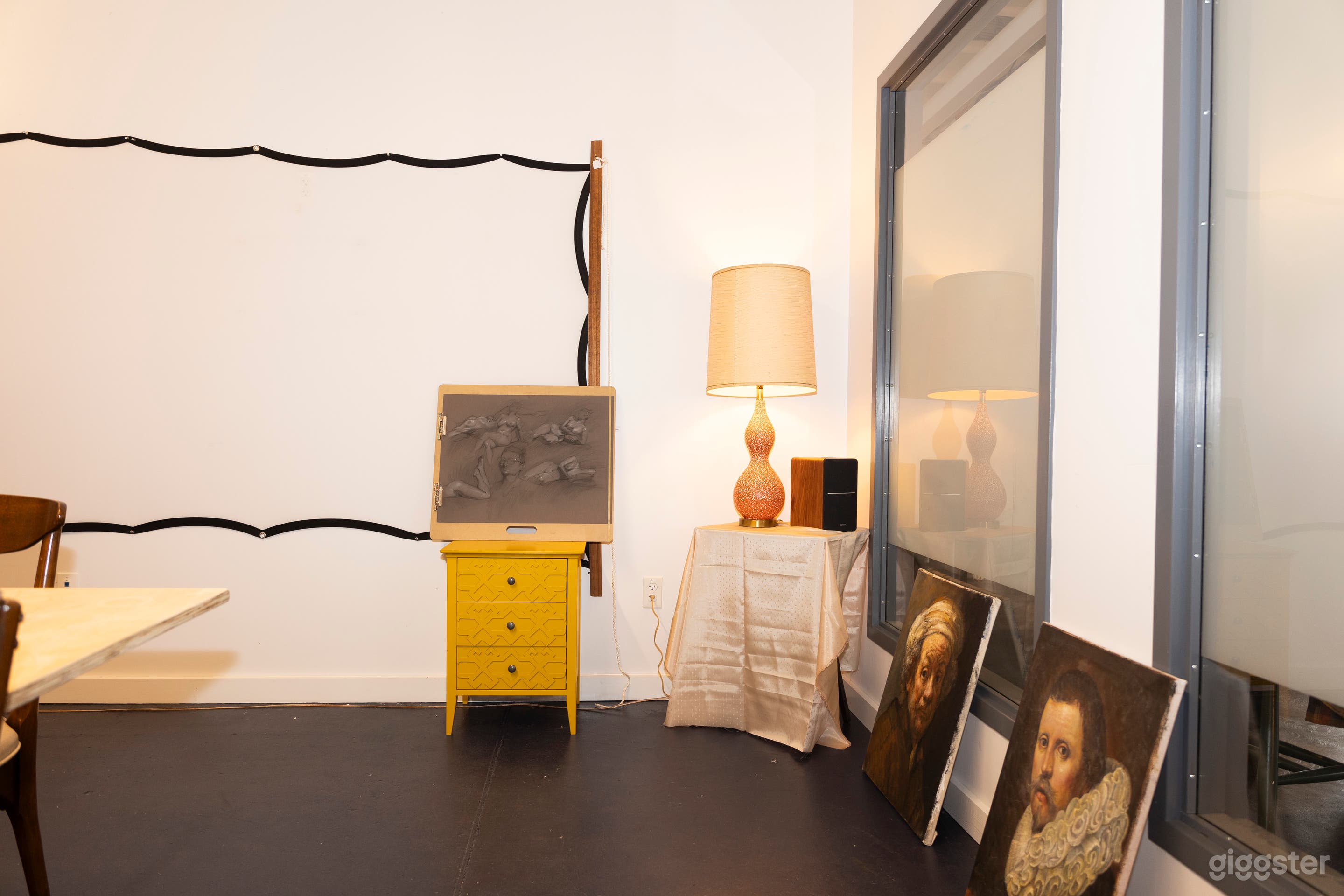 Our projection screen against the wall with various furniture pieces and art. 