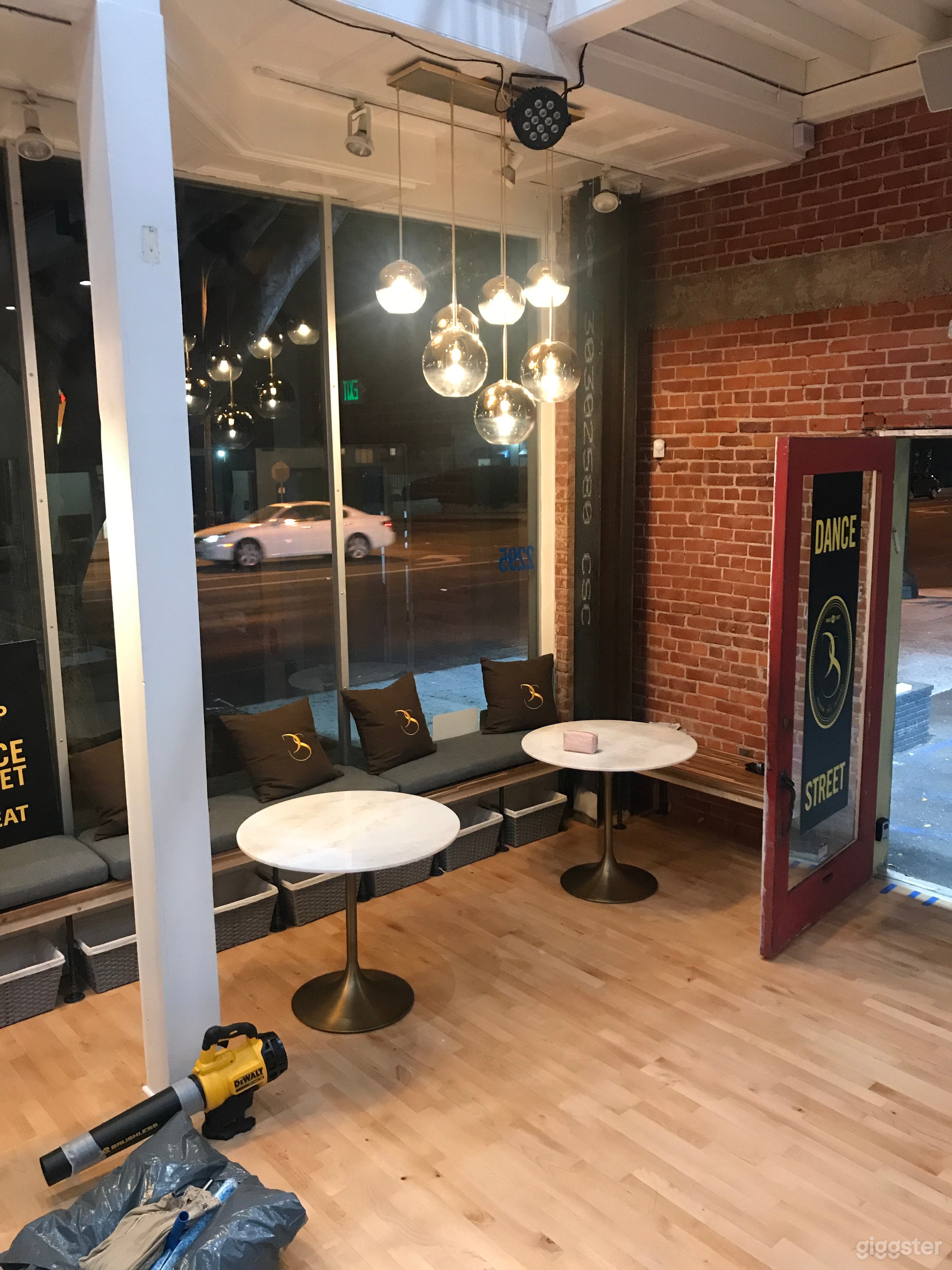 Door/Entrance 


Seating on the right hand side with 3 tables and Chairs that are provided

Above you will see our Chandelier bulb lights that shine onto our white marble round tables.