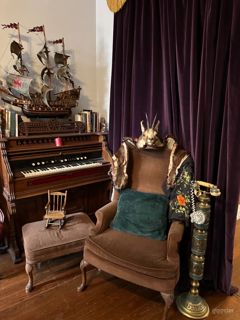  A different angle for you shows you arm chair w draped taxidery goat, its acually a goat head rug but dont trip on it, you can place it back on ground for a shoot &amp; don&#x27;t move the delicate cutter, the pirate ship is a great one! 