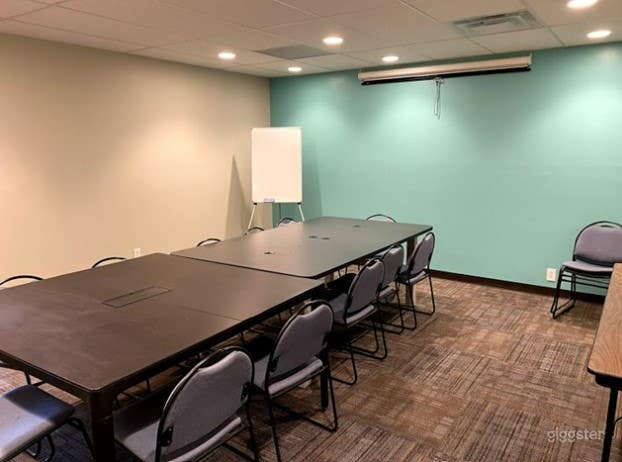 Conference room with screen, projector, and whiteboards