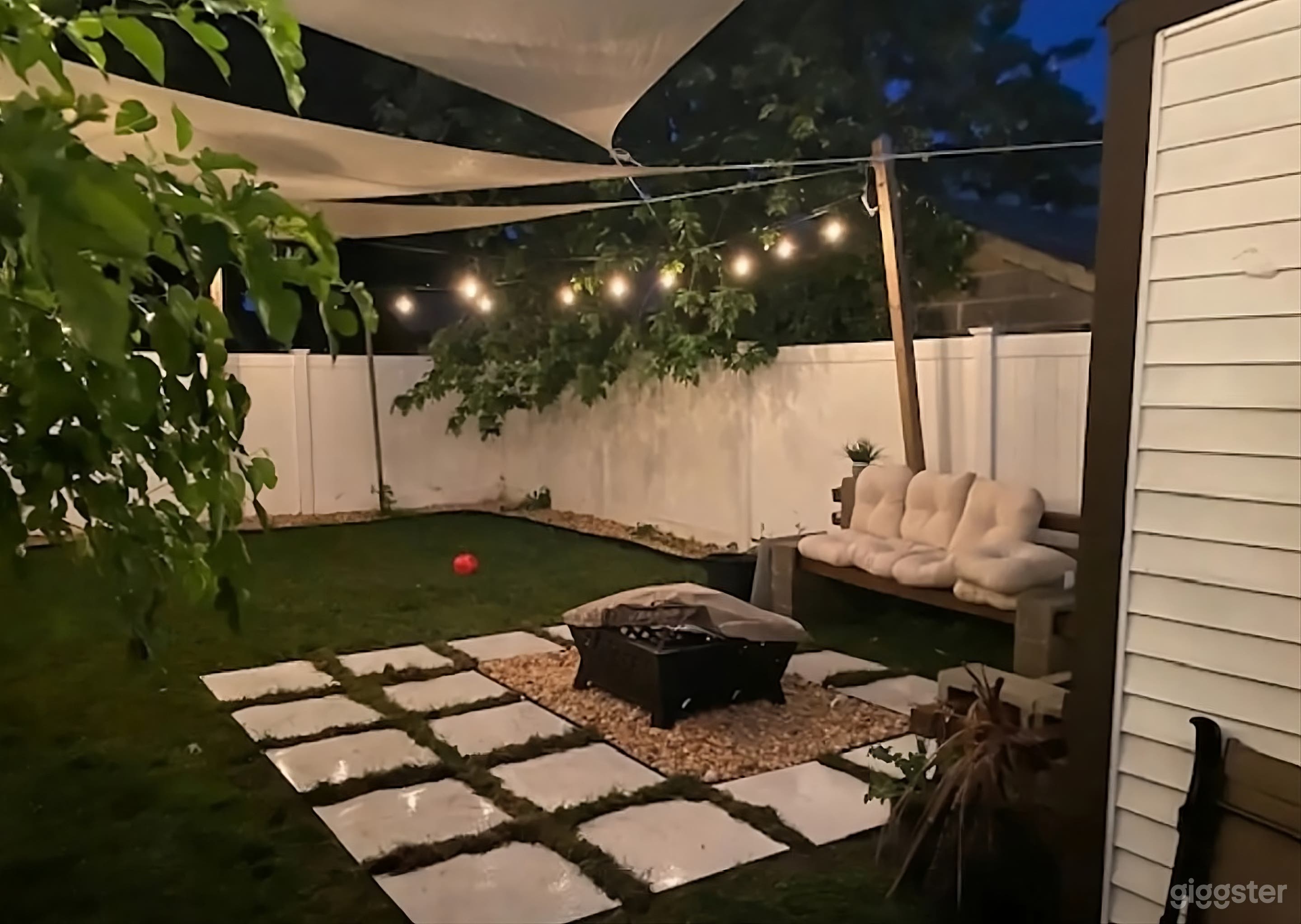 Cozy Fenced Lush Backyard Photo 1