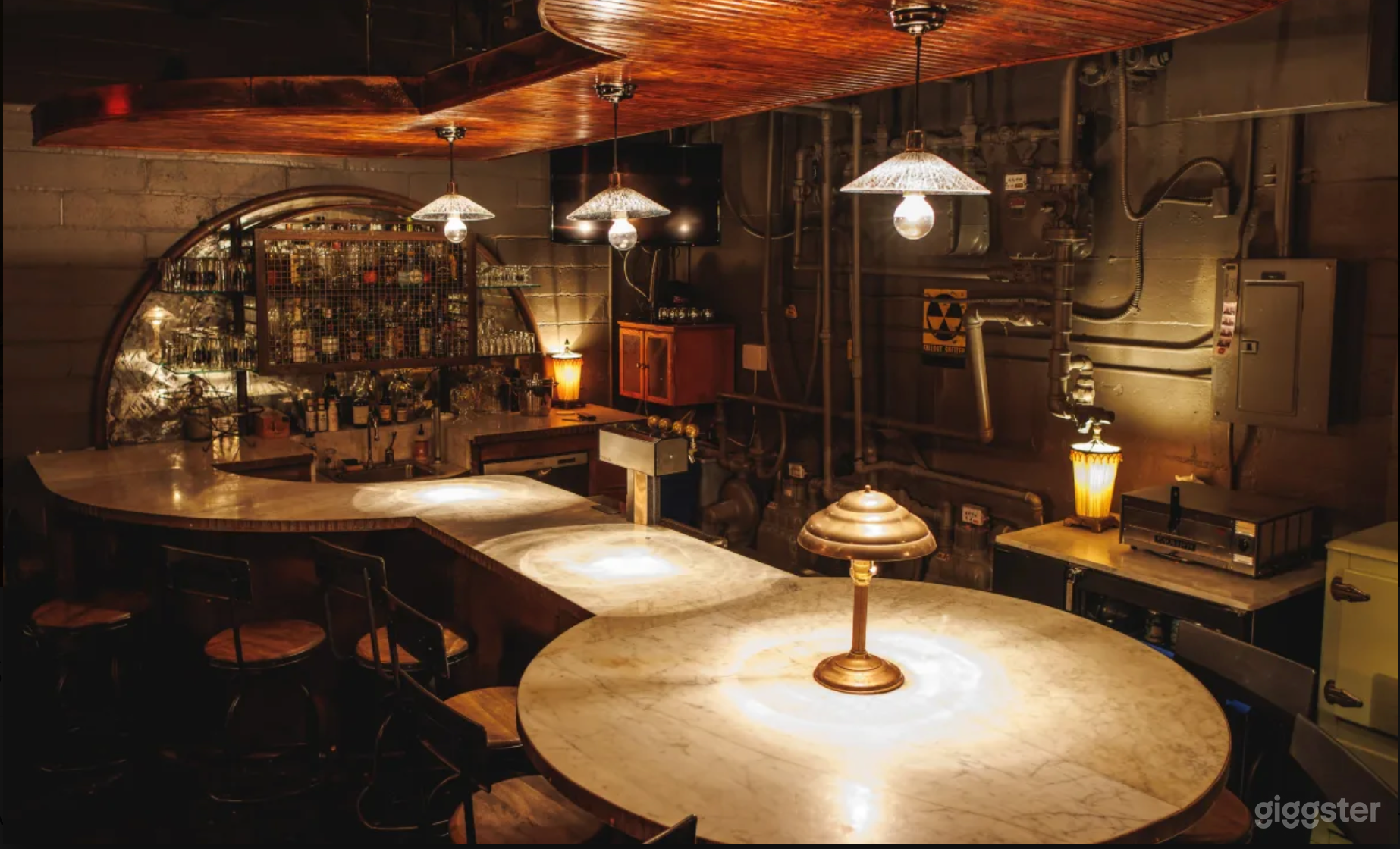 Speakeasy-style bar with seating for 15 and sink, fridge, ice tubs, and more.
