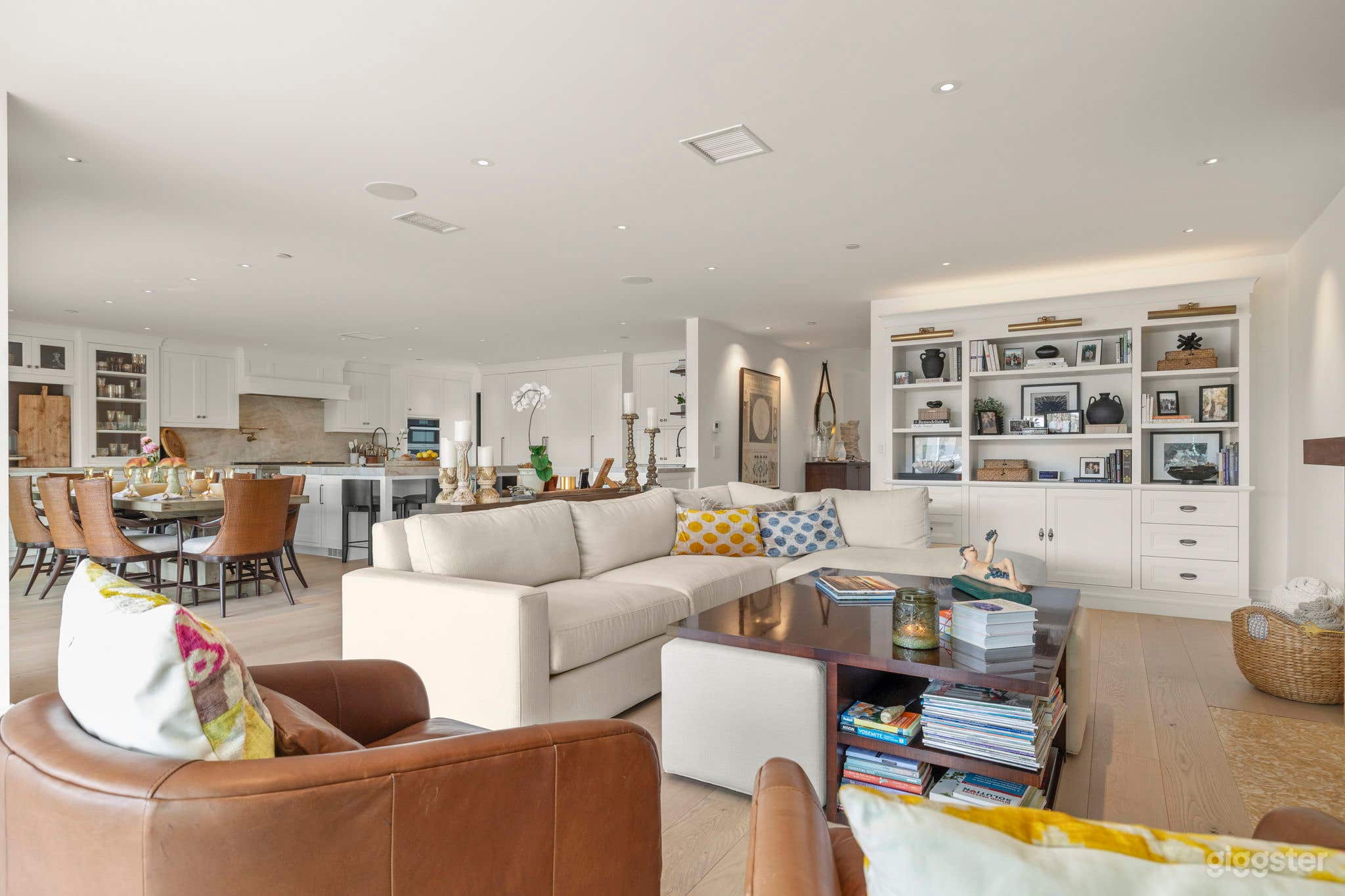 Living room and kitchen area with a modern beach house interior. 