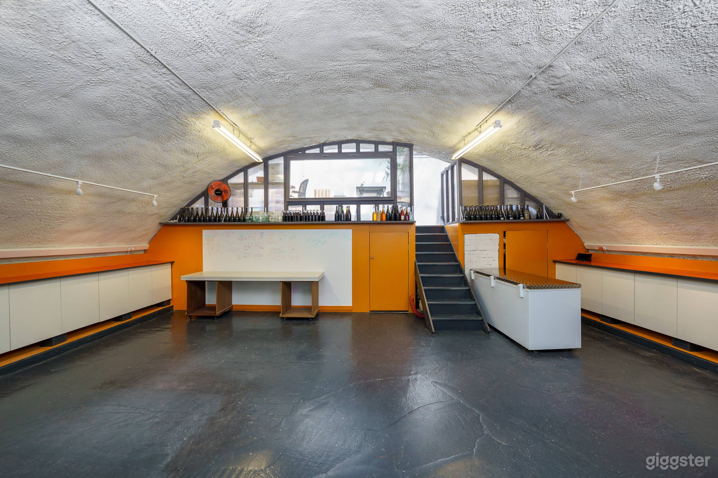 Main space with upstairs for changing or coats