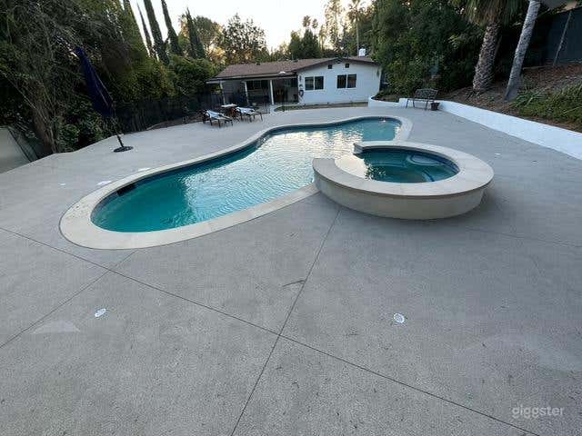Inviting Outdoor Pool with Jacuzzi for Production Photo 4