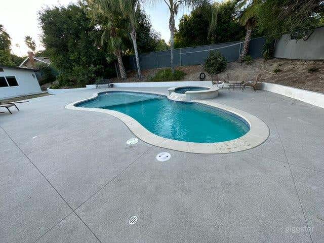 Inviting Outdoor Pool with Jacuzzi for Production Photo 1