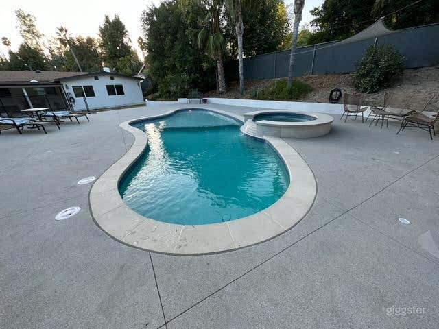 Inviting Outdoor Pool with Jacuzzi for Production Photo 3