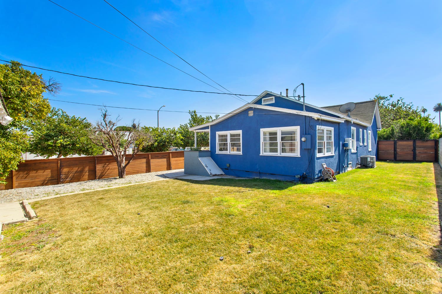 Wood Fenced-in yard with lush green grass  