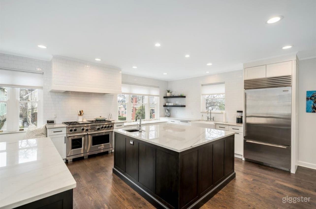White, open chef’s kitchen with two large islands 