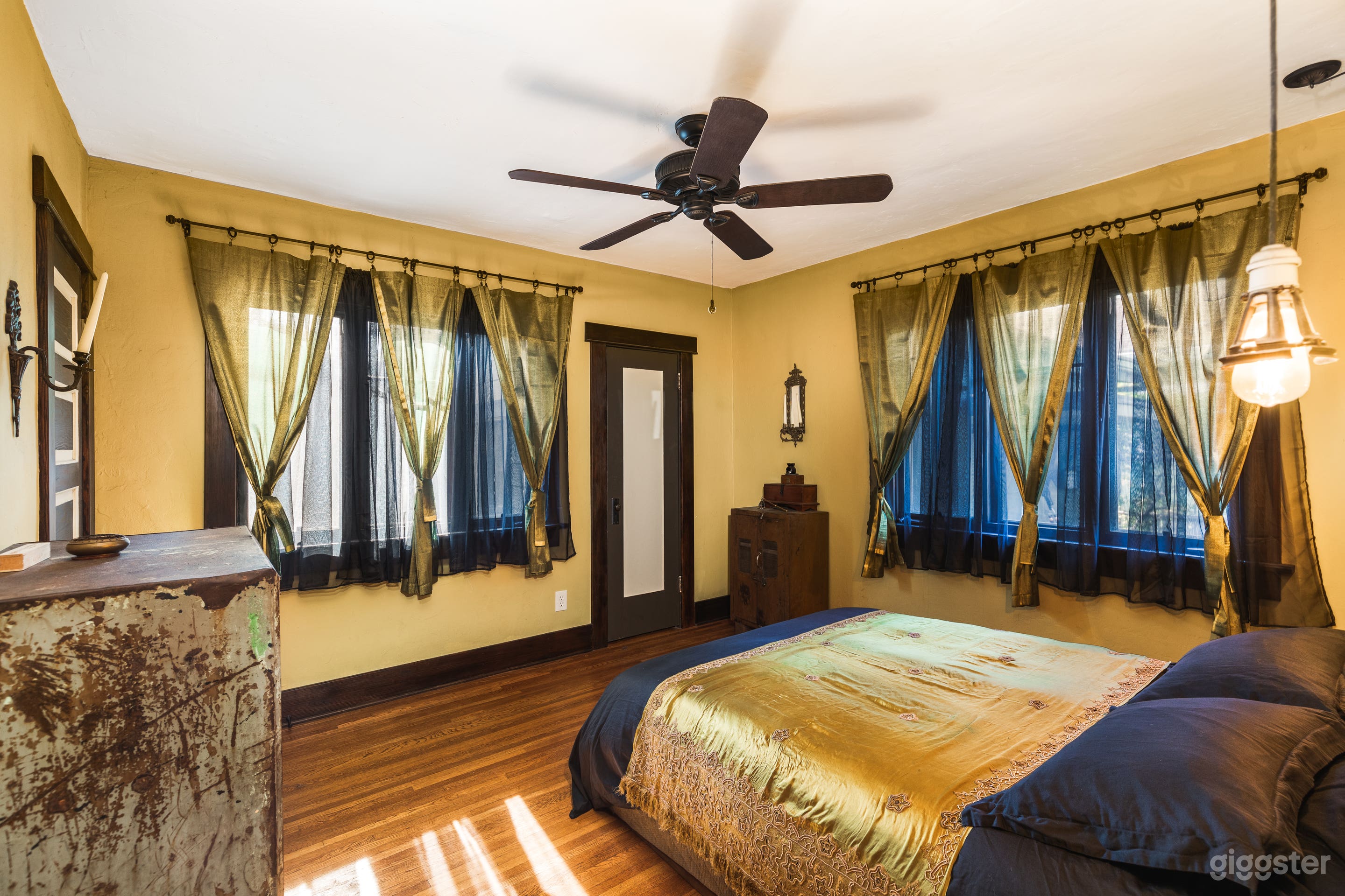 Master Bedroom with Indian silk drapes and Industrial-chic armoires