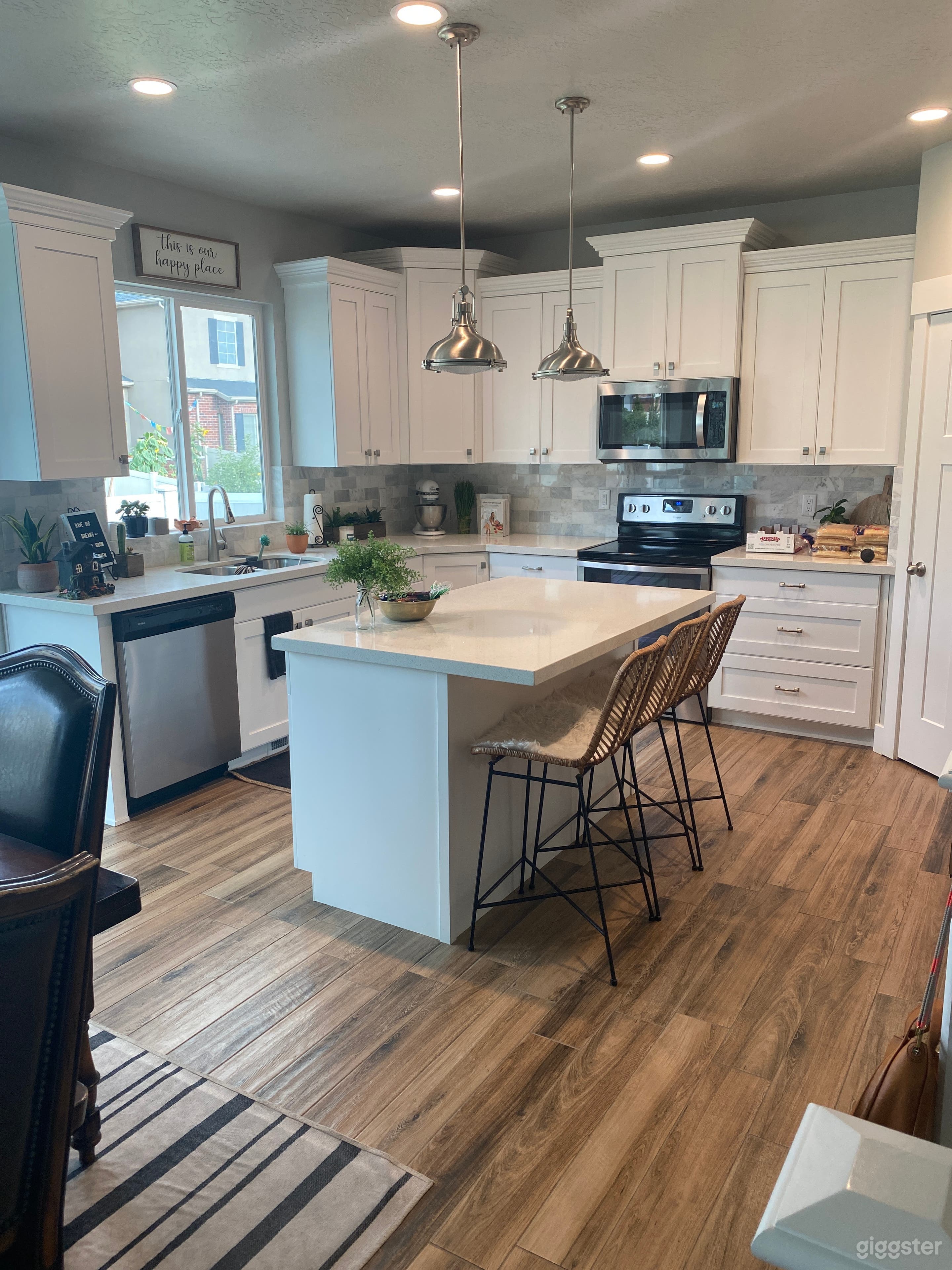 White kitchen with stainless steel appliances.