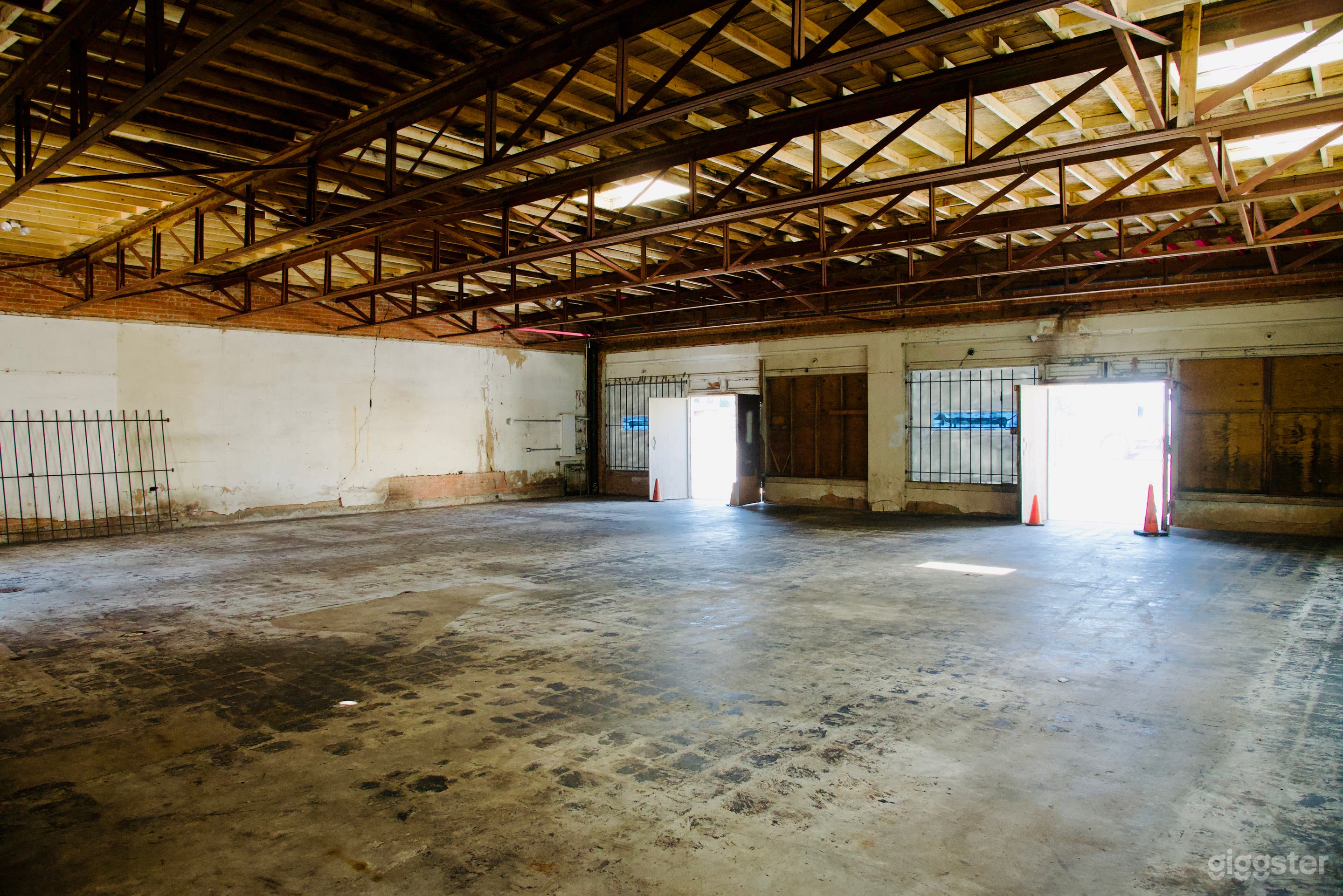 Main Room: 50 x 50 sq/ft 
6 ft. front doors to street
Left wall with 30 amp electrical panel.