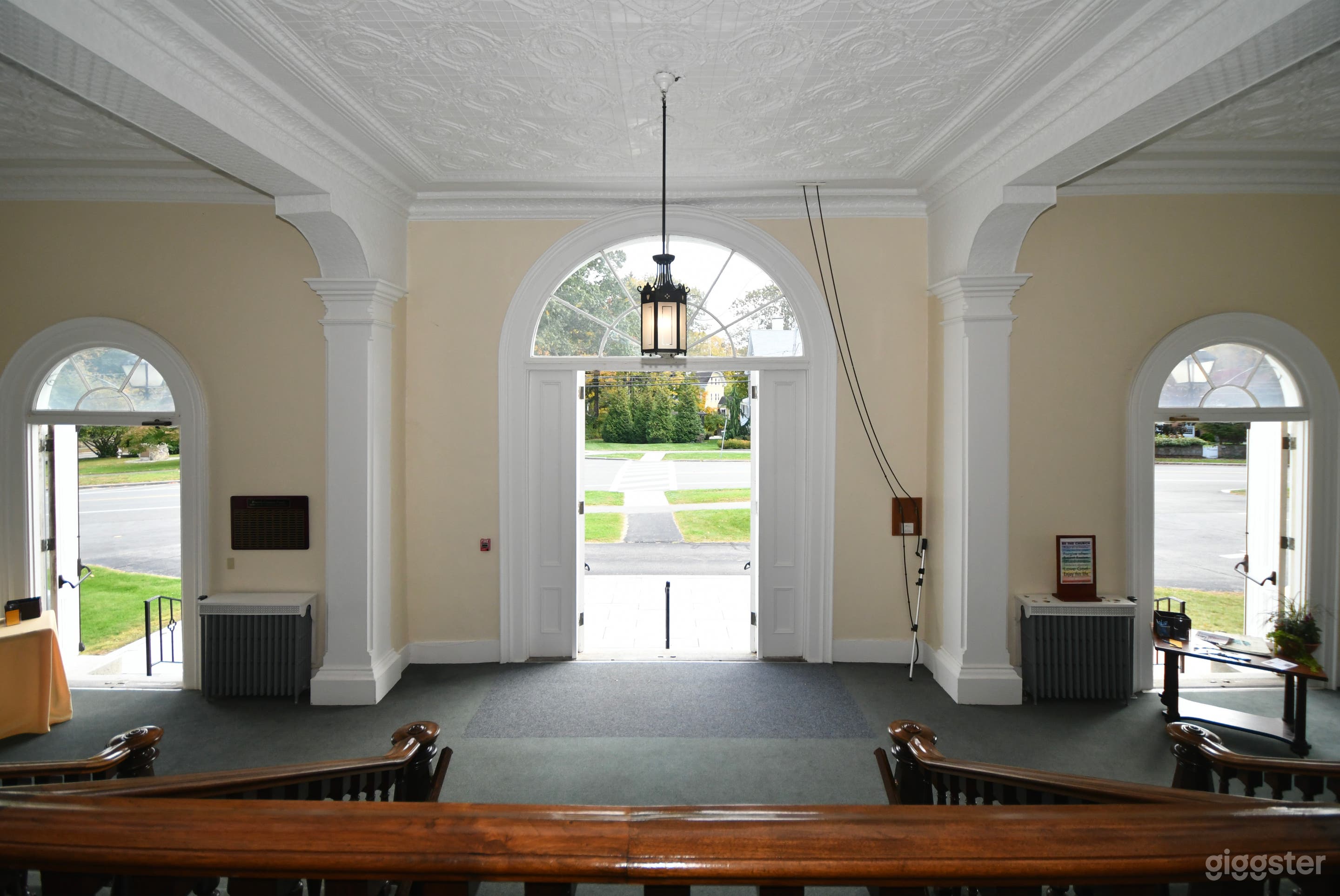 Narthex (image 1 of 3): Large, high-ceiled, multilevel entry gathering space with multiple staircases including curved staircases. 