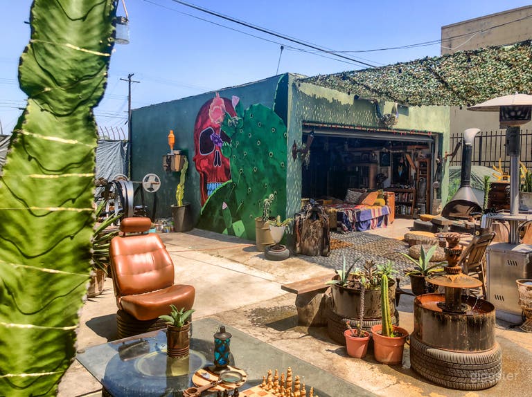  Alternative view of rustic back courtyard, fireplace, artist nook, and mural by artist Trek Thunder Kelly. 