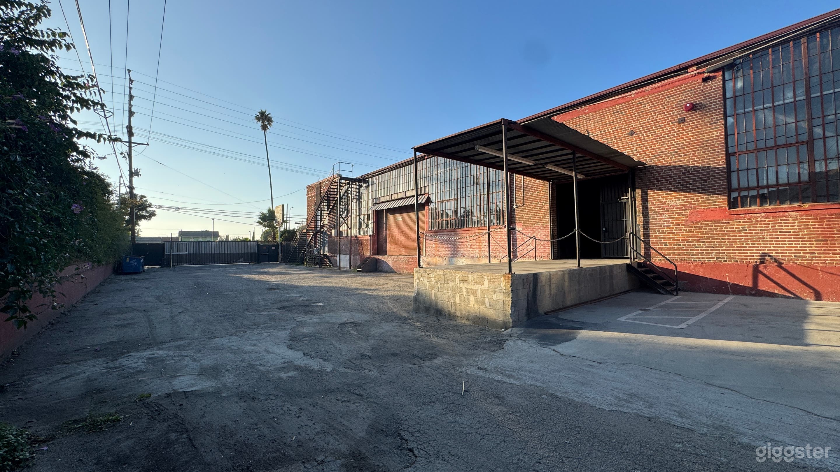 Industrial Red Brick Exterior Gated Parking Lot Photo 4