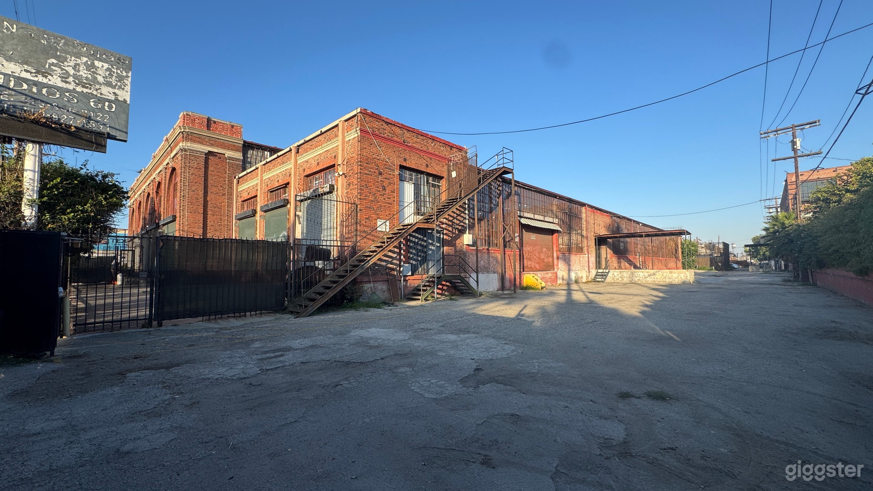Industrial Red Brick Exterior Gated Parking Lot Photo 2